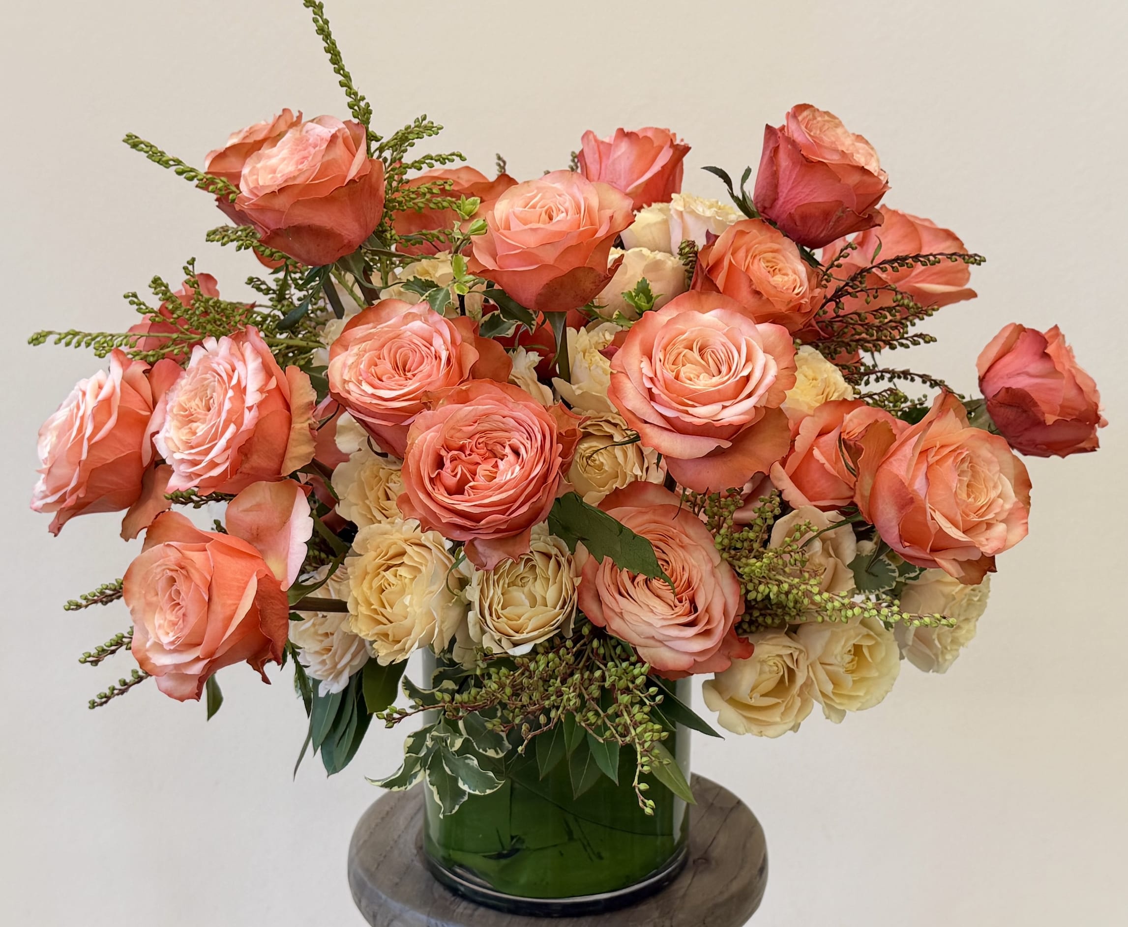 The Summer Spread Arrangement. - She is just so pleasing to the eye with roses ranging from peachy, sandy or tan seasonal Spray Roses to Moody Peach Roses (Kahala) mixed with chic, summer greenery in a 5"cylinder vase.