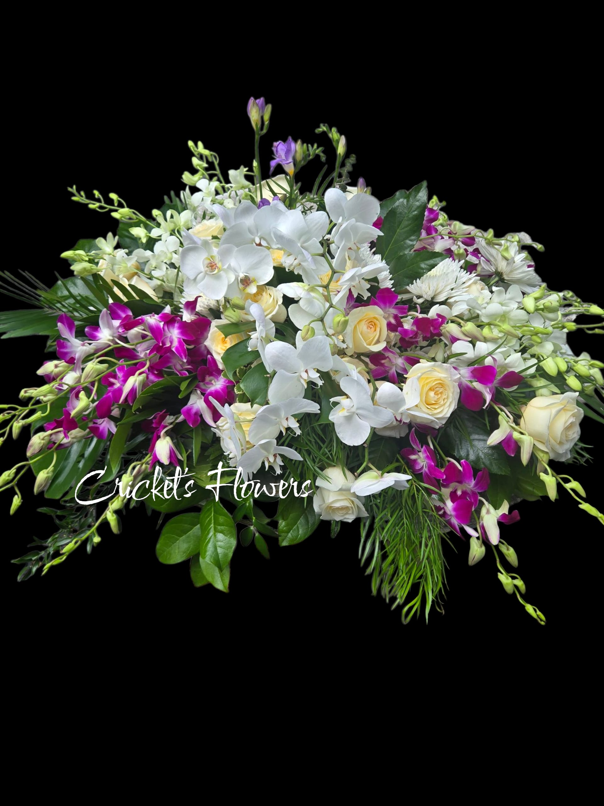 White orchids and cream roses with purple orchids in a low arrangement