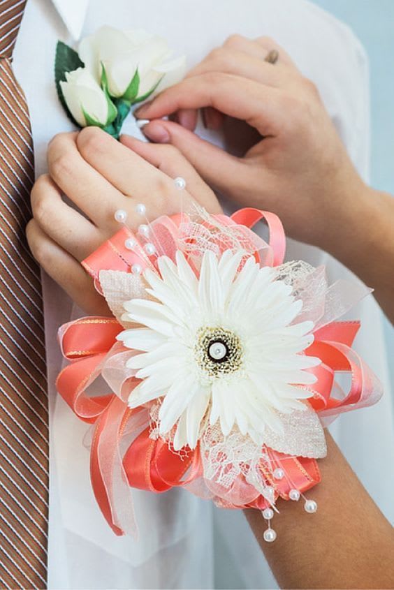 White gerbera daisy corsage with pink ribbon and pearl accents