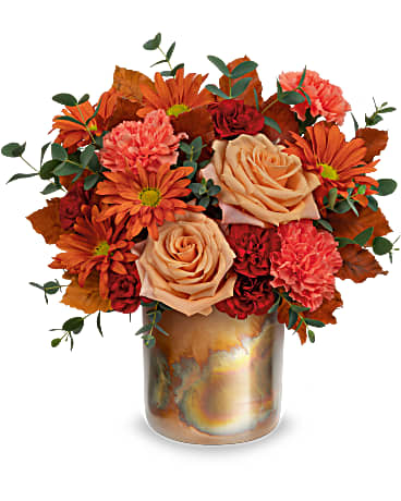 Copper Rose Bouquet - Teleflora's Copper Rose Bouquet stunning fall bouquet certainly leaves them breathless! Brimming with lush roses and blooms, this copper-finished metal vase with a patina finish that can be used as a planter later. This warm-toned bouquet has light orange roses, orange carnations, miniature maroon carnations, bronze daisy spray chrysanthemums and brown copper beech arranged with parvifolia eucalyptus. The Copper Rose Bouquet is delivered in Teleflora's Harvest Blooms Cylinder. Approximately 12 1/2" W x 12 1/2" H