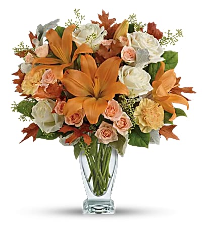 Seasonal Sophistication - Capture the natural beauty of autumn with this stunning arrangement of lilies and roses in an elegant glass vase, sure to brighten any fall day. 