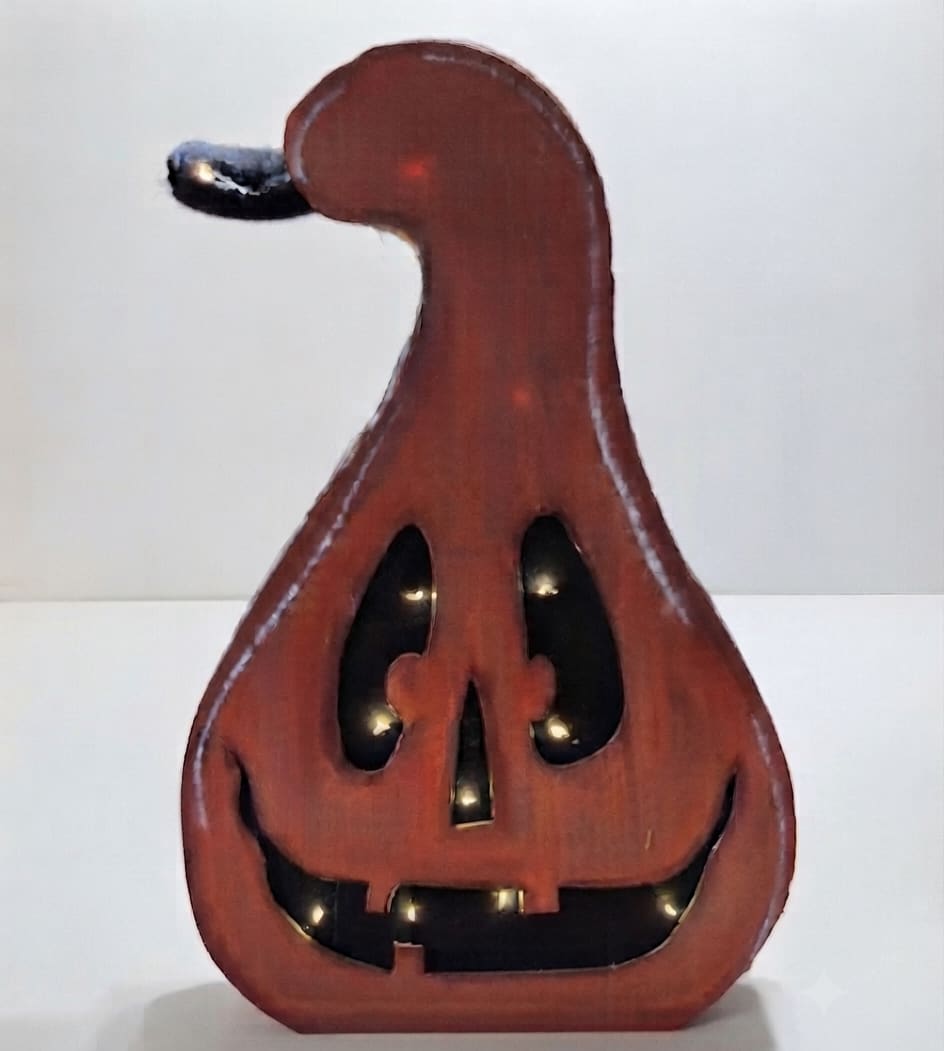 Wooden jack-o'-lantern decoration with a carved smiling face