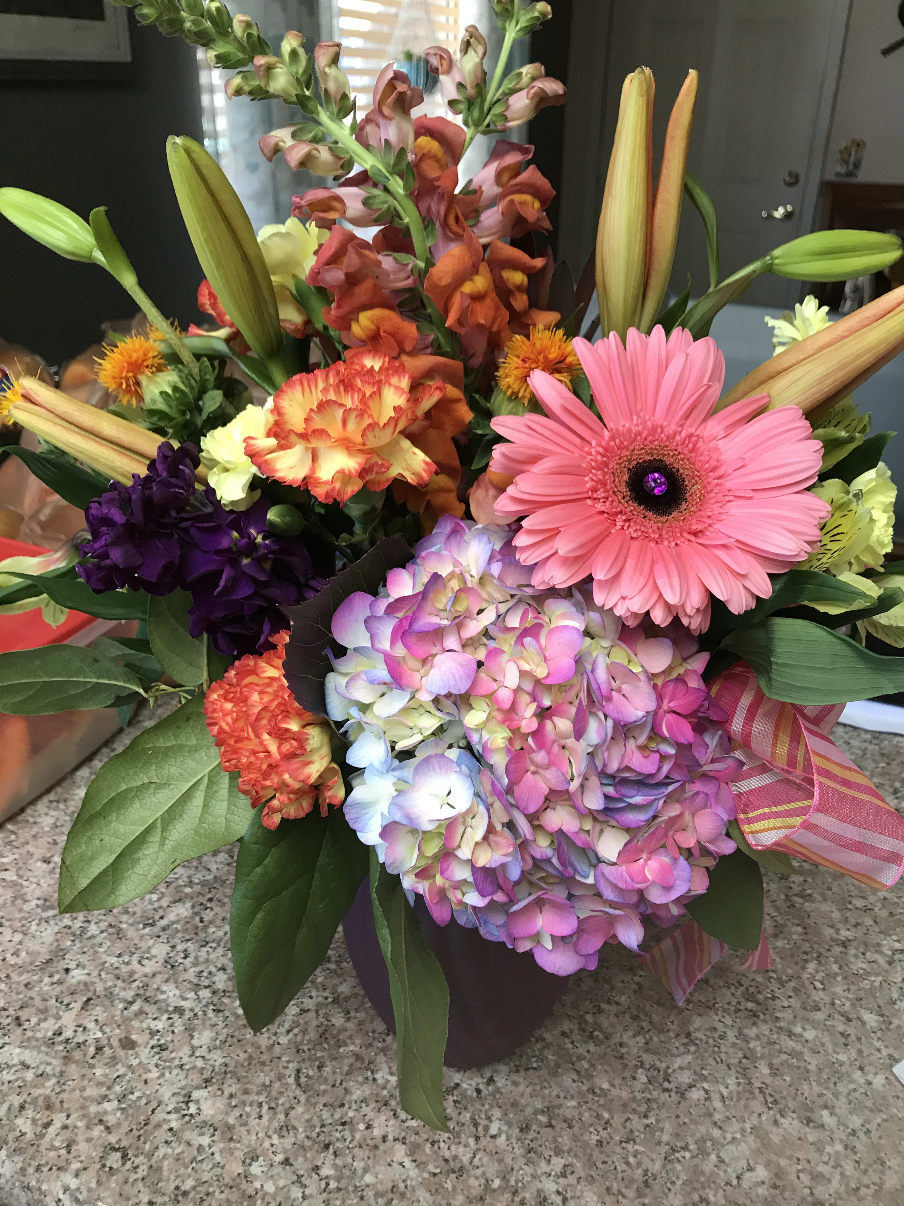 Colorful mixed bouquet with gerbera daisy, hydrangea, lilies, and snapdragons