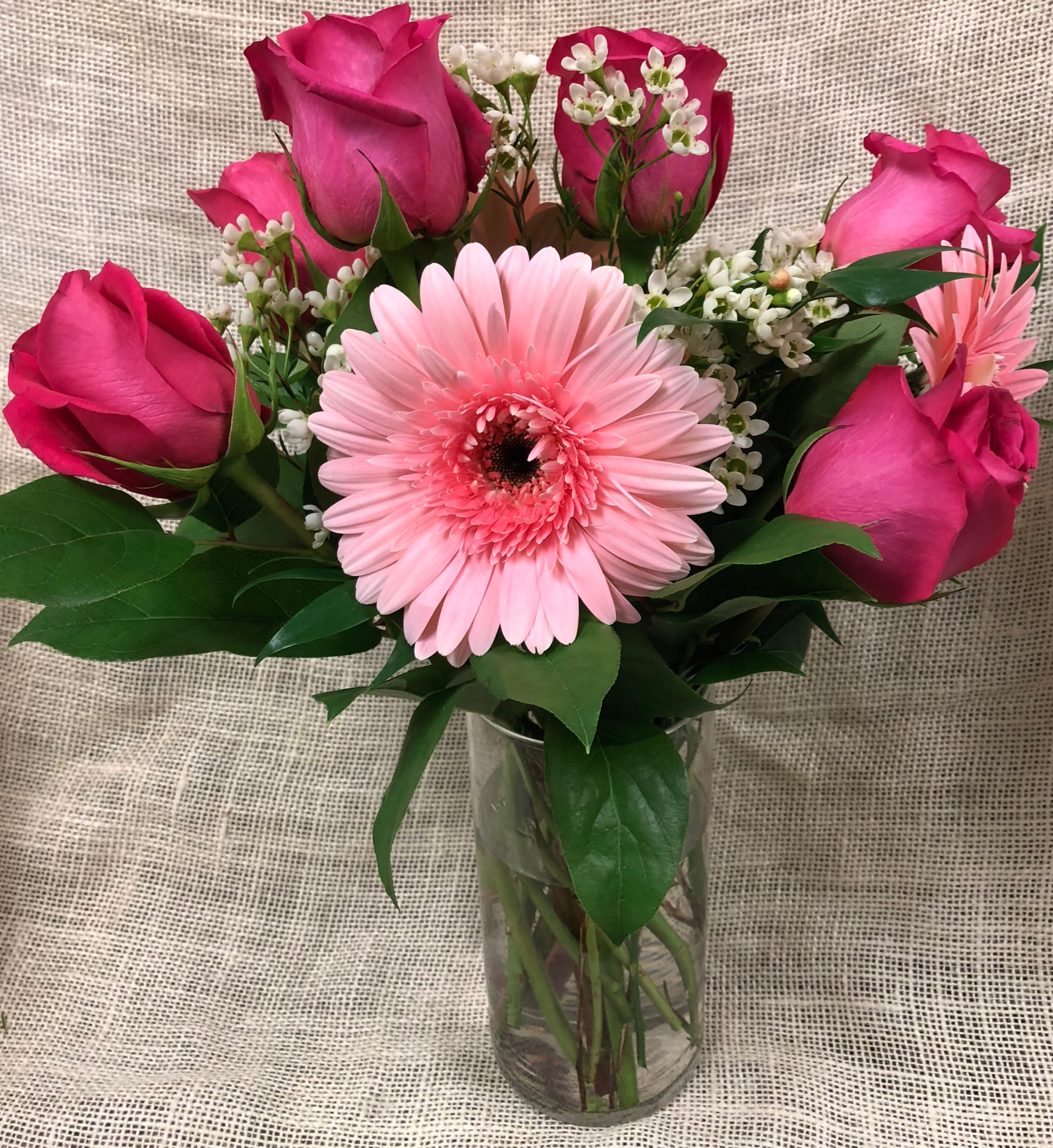 Tickled Pink - Roses and Gerbera Daisies - This lovely arrangement of 6 pink roses and 3 complementary pink colored gerbera daisies is sure to delight the recipient! Designed with greens and accompanying accents. To boost the "wow" factor, upgrade to Deluxe (9 roses, 5 gerbs) or Premium (a Dozen roses plus 6 gerbs)