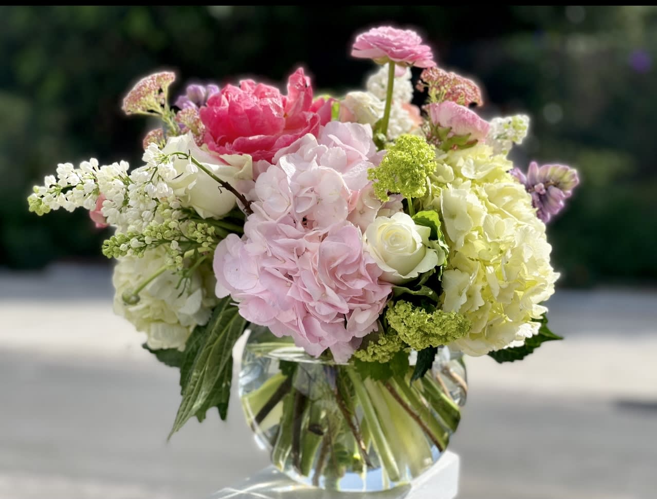 Pink and white floral arrangement in a clear glass vase