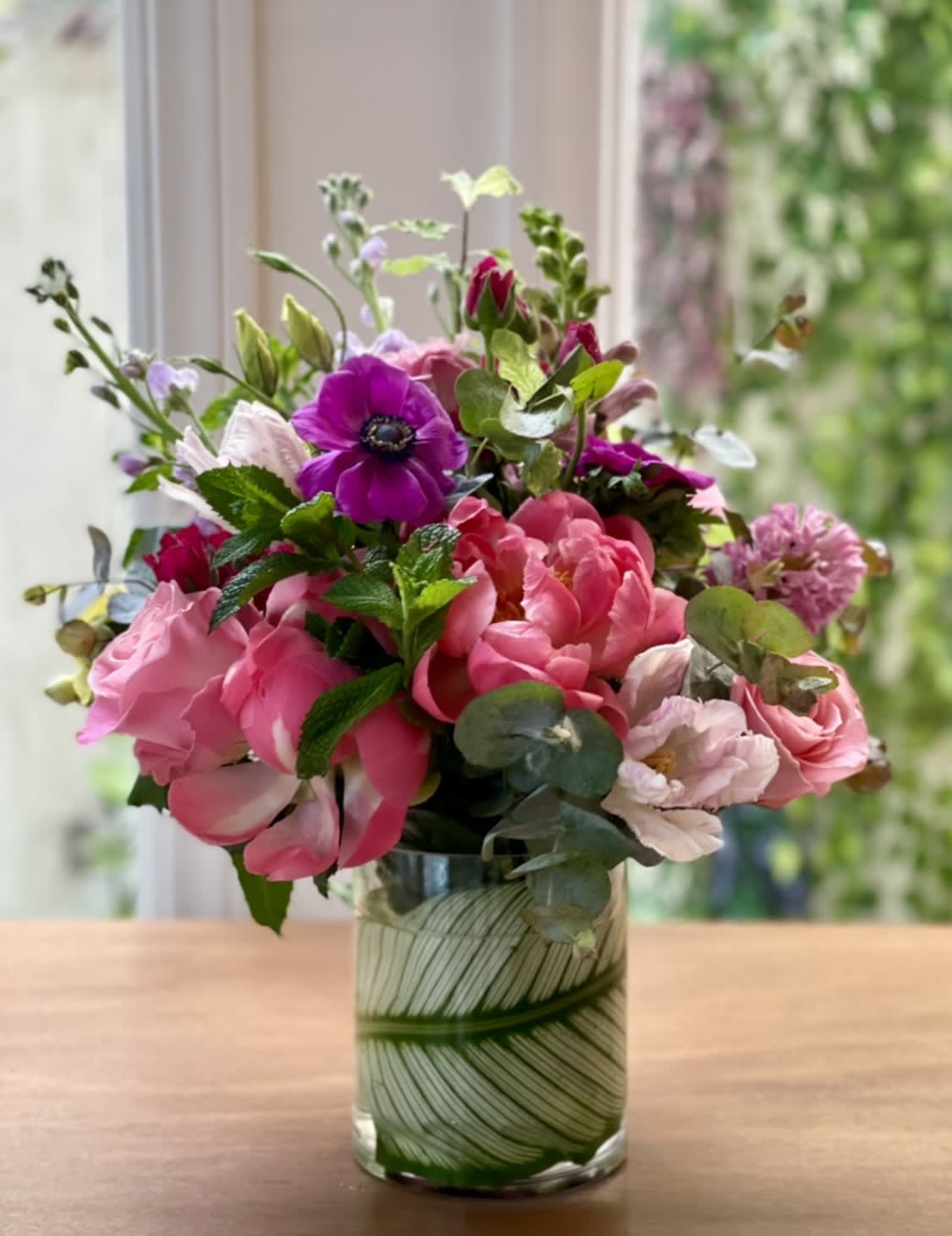 Pink and purple mixed bouquet in a glass vase