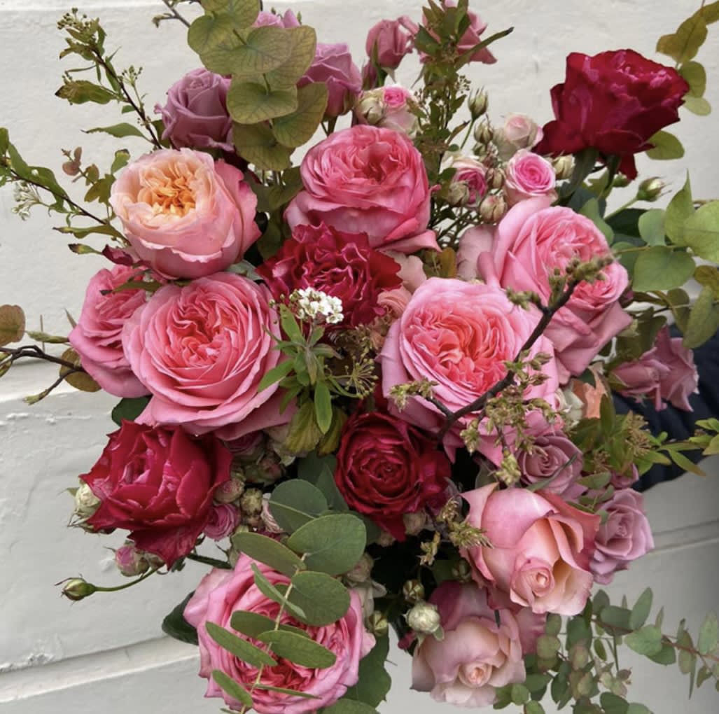 Bouquet of pink and red roses with eucalyptus