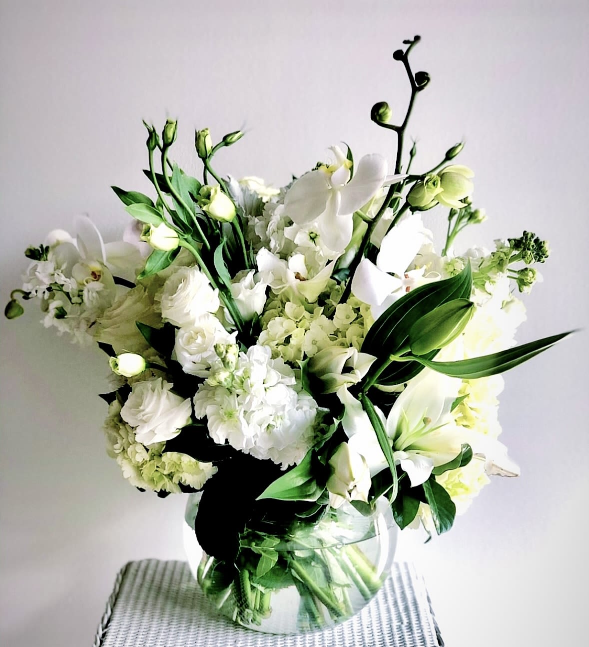White floral bouquet in a clear glass vase