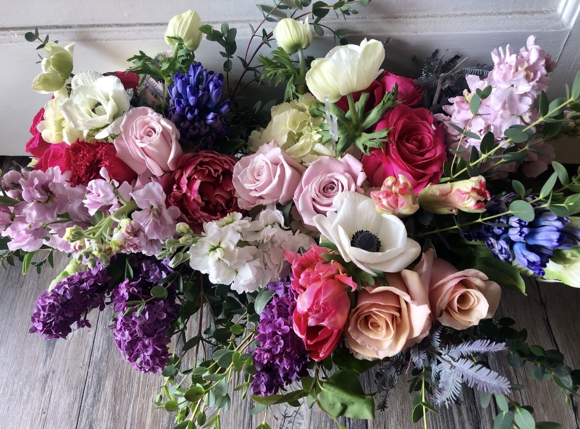 Mixed bouquet of roses, anemones, and hyacinths in pink, white, purple, and red