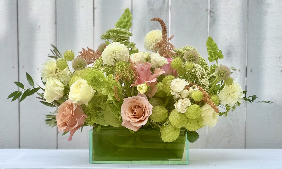 Mixed pastel bouquet in a green rectangular vase