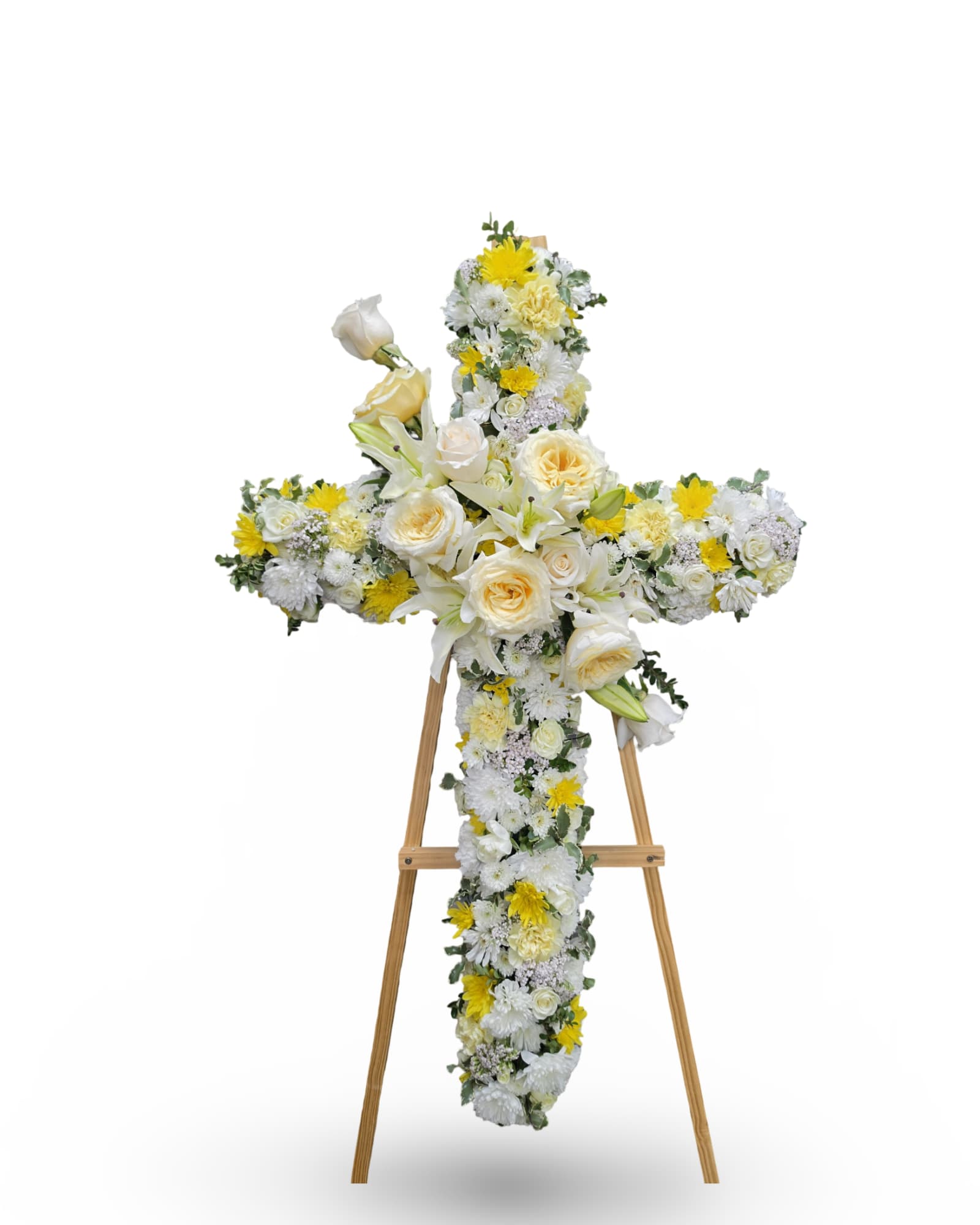 Cross-shaped floral tribute on a wooden easel with white and yellow flowers
