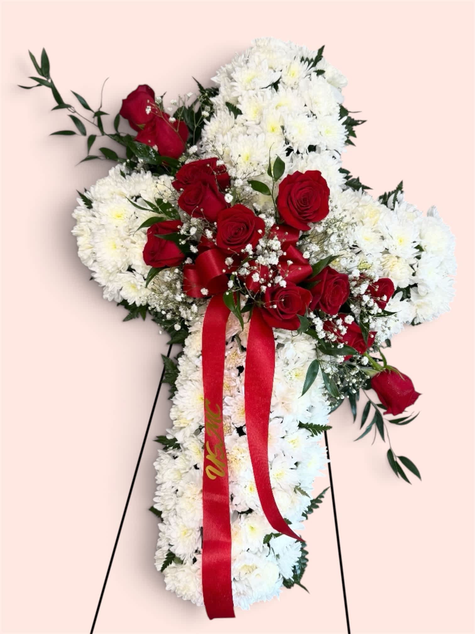 Standing floral spray of white chrysanthemums and red roses with a red ribbon