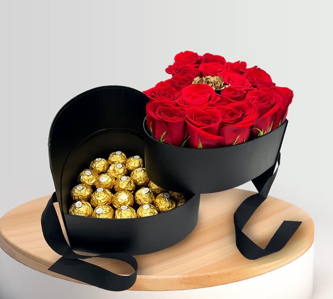 Heart-shaped box with red roses and gold-wrapped chocolates