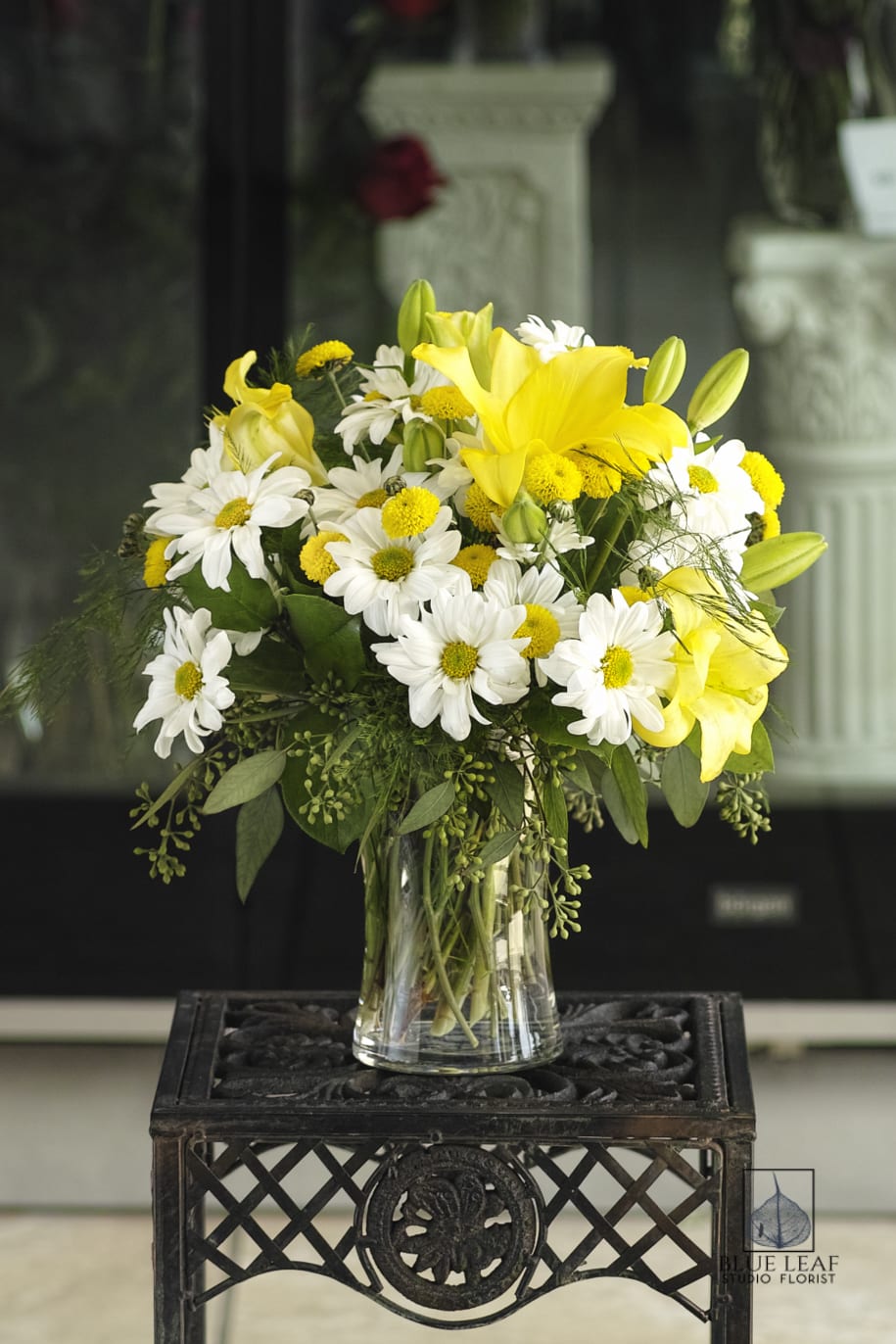 Sunny day - A vase of yellow lilies white daisies. A cheerful arrangement to greet the day.   