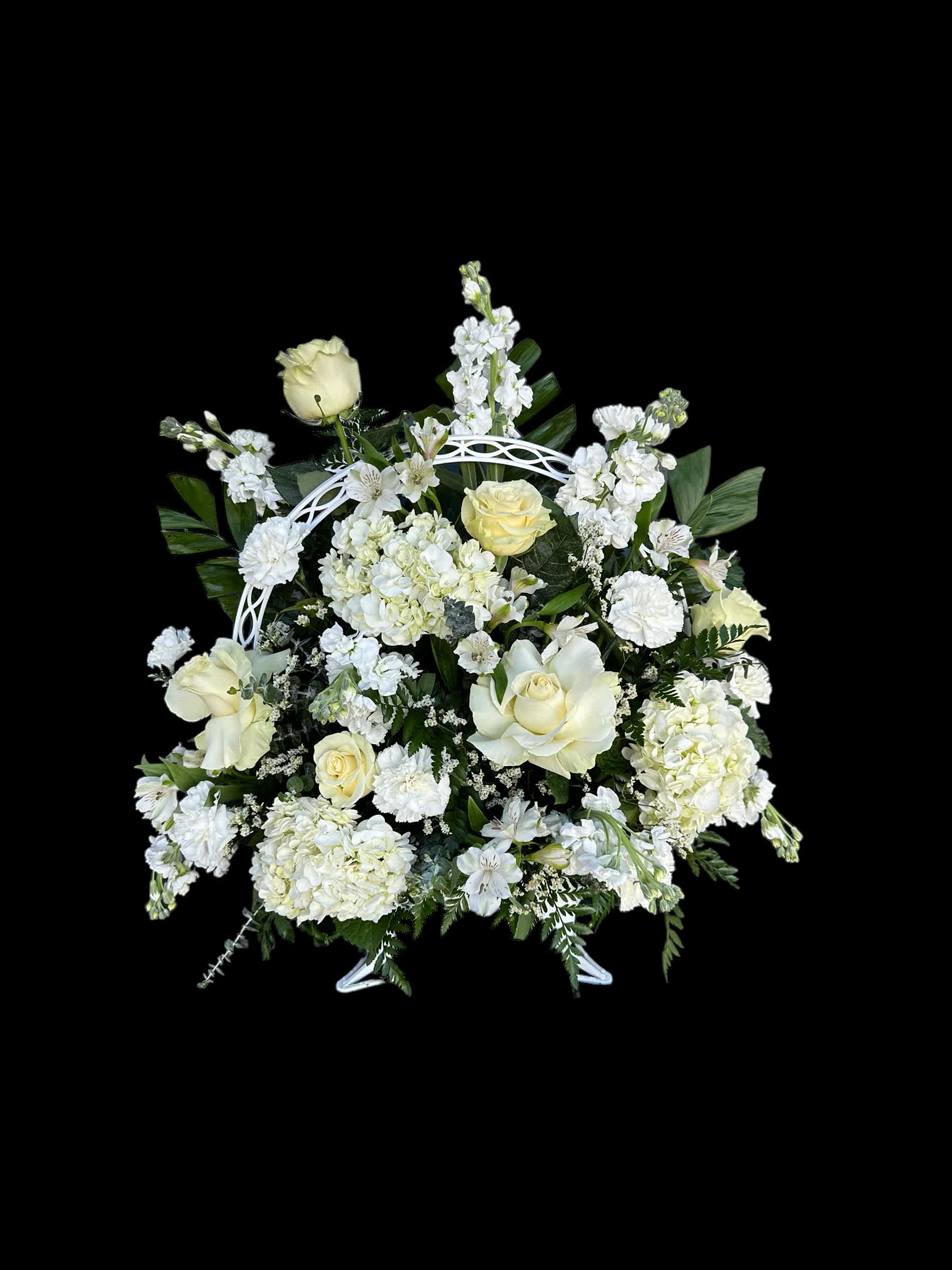 White floral arrangement with roses and hydrangeas in a white stand