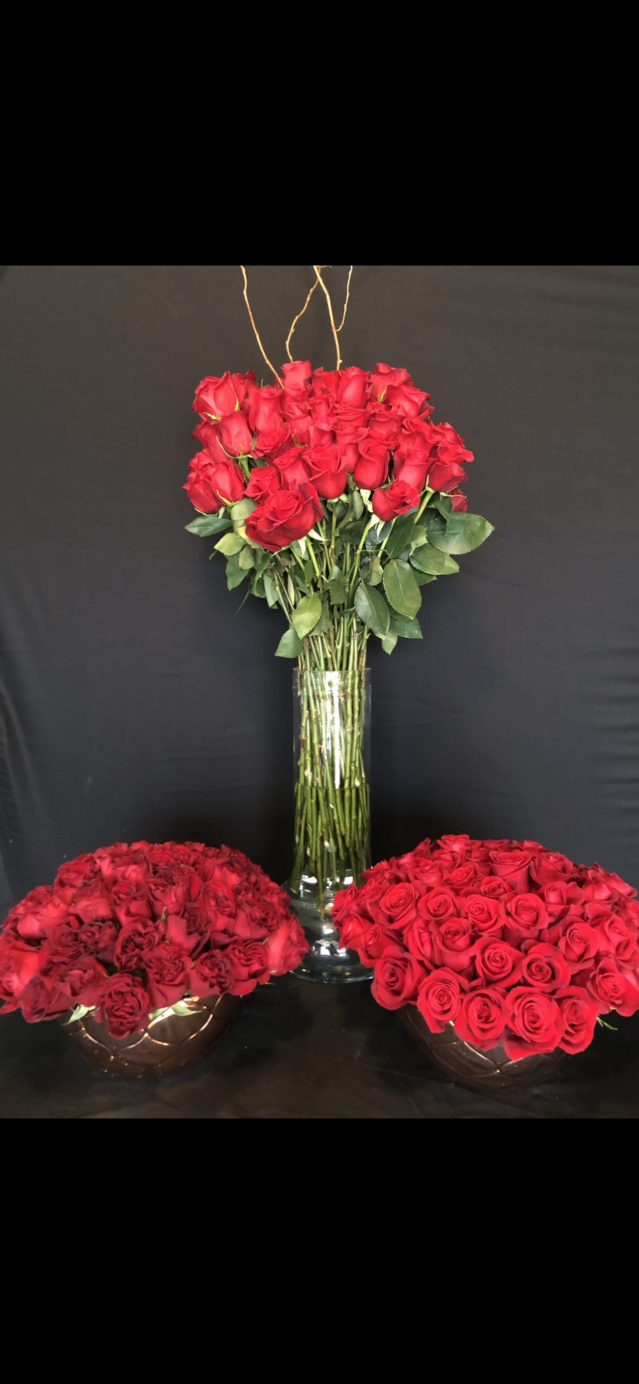 Madly in Love.12 dozen roses.  - This red rose package will make her feel your love for days and days!  Two rose bowls and one tall clear glass vessel filled with all reed roses.  144 roses total. 