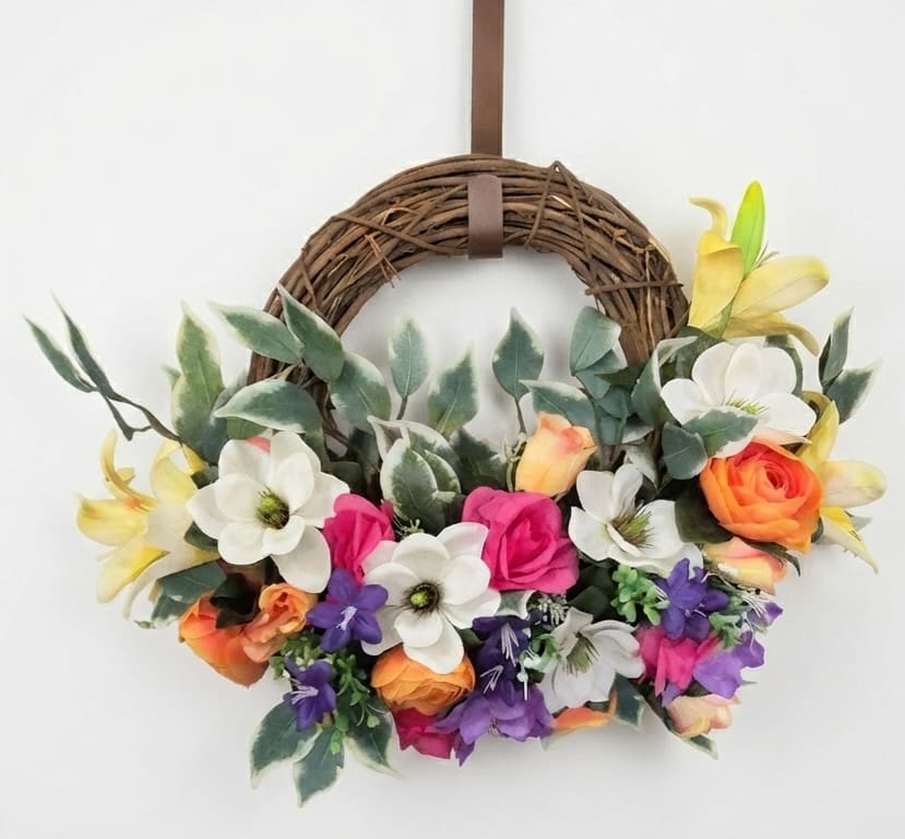 Floral wreath with colorful blooms on a grapevine ring