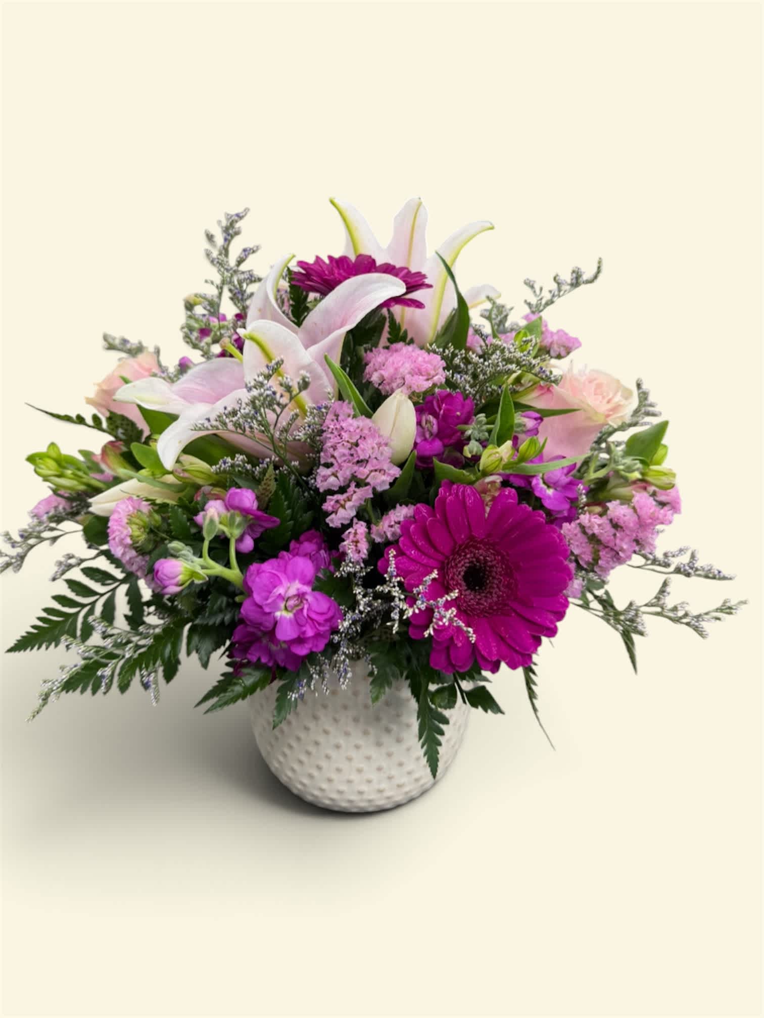 Pink and white mixed flower arrangement in a white textured vase