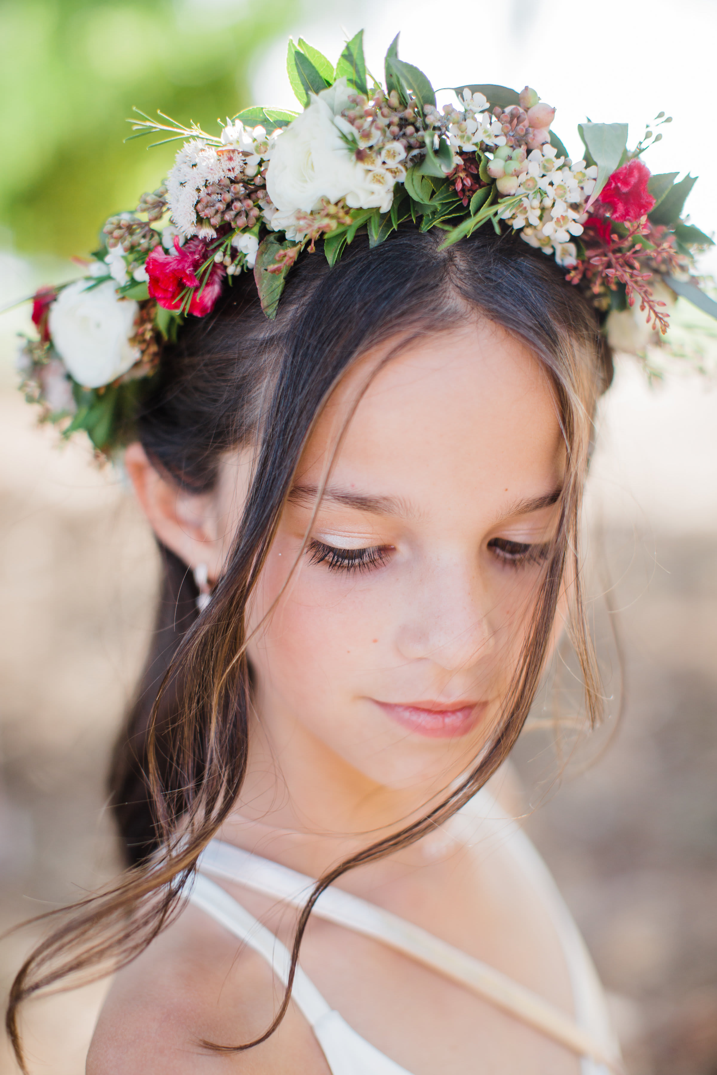 Girl wearing a floral crown with white and pink flowers