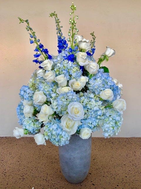Happy View ( 5’ tall ) - Blue Hydrangeas , White Roses , Delphinium in ceramic vase. 5 ‘ tall 