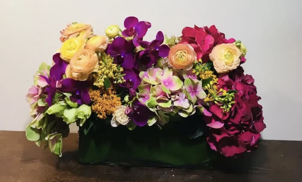 Colorful floral arrangement in a dark rectangular container