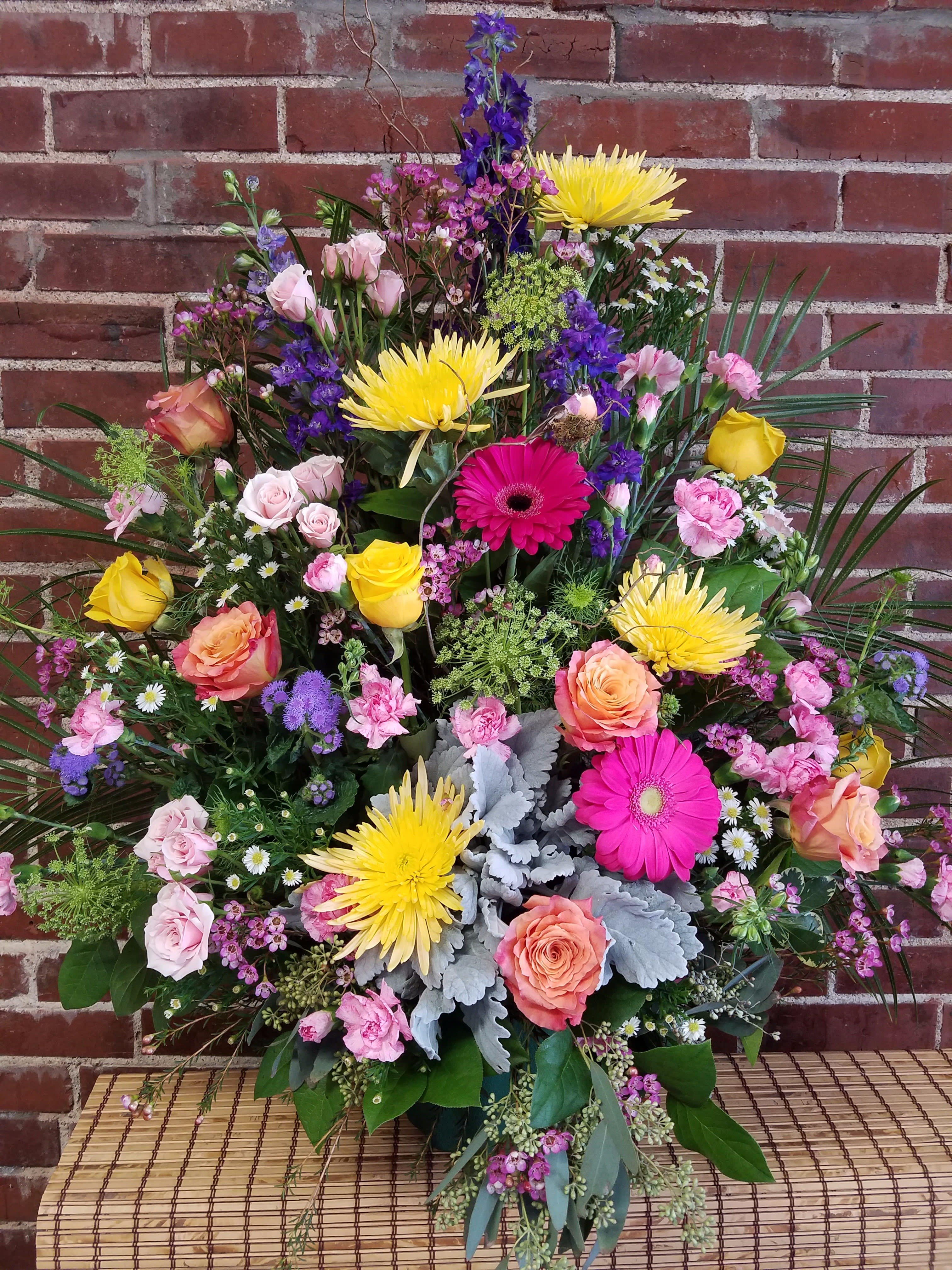 Large mixed bouquet with roses, gerbera daisies, and purple blooms