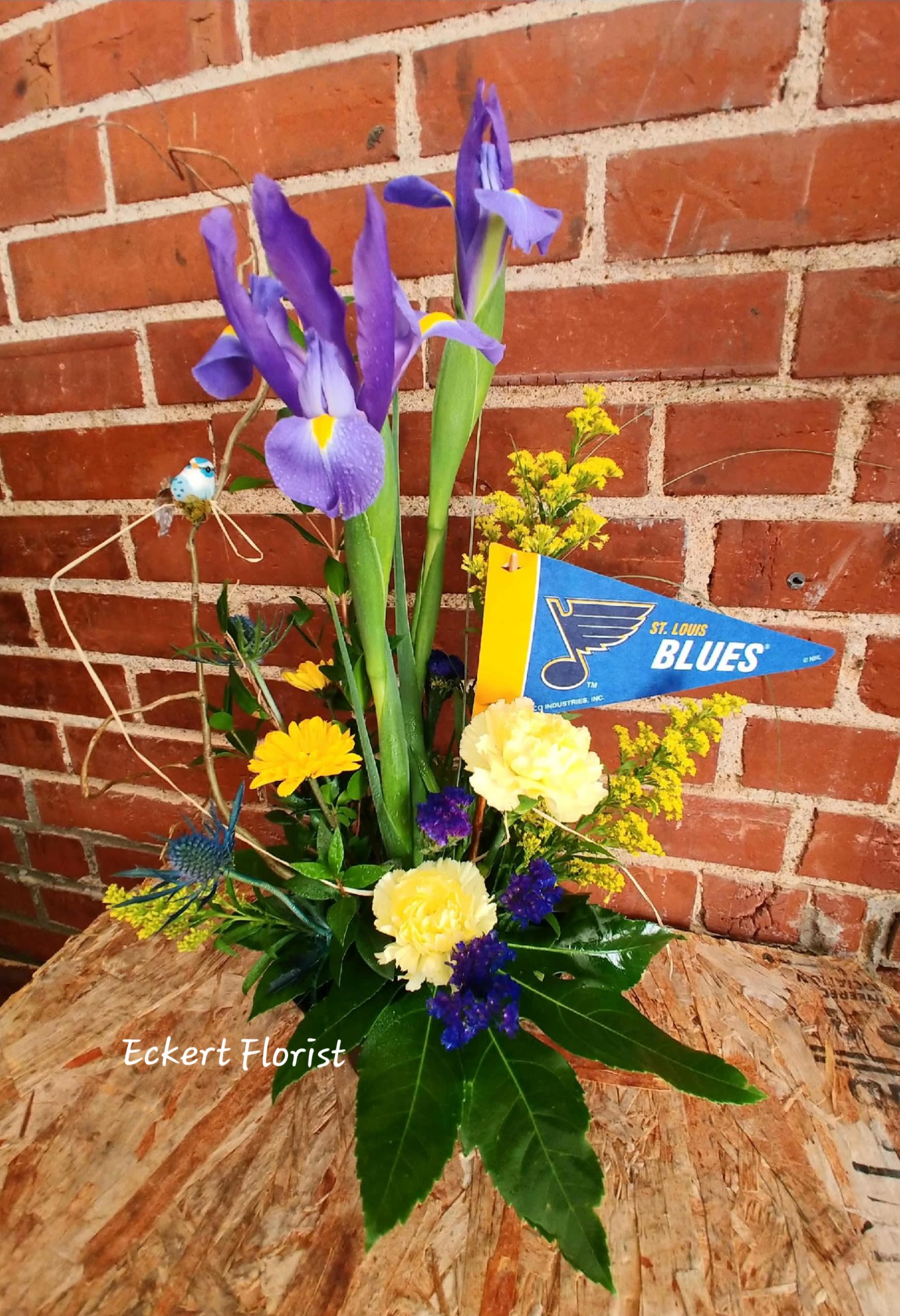 Purple irises with yellow and blue flowers in a low arrangement