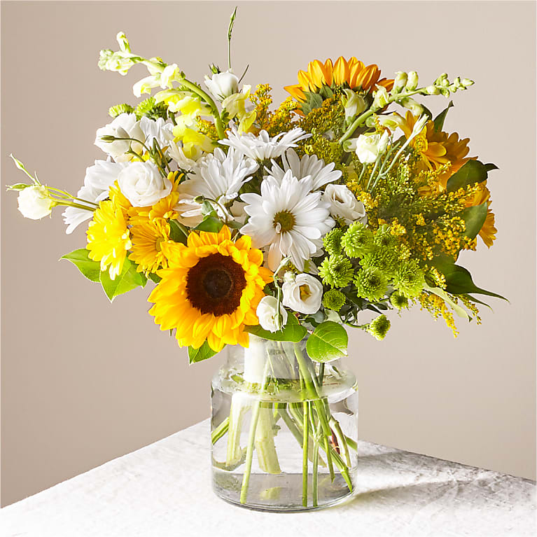 Eckert Florist's FTD Hello Sunshine Bouquet - Give a dose of sunshine in bloom. This stunning bouquet is teeming with rays of blooms to deliver the perfect pick–me–up for an occasion or as a treat to yourself. *Flower variety and colors may vary