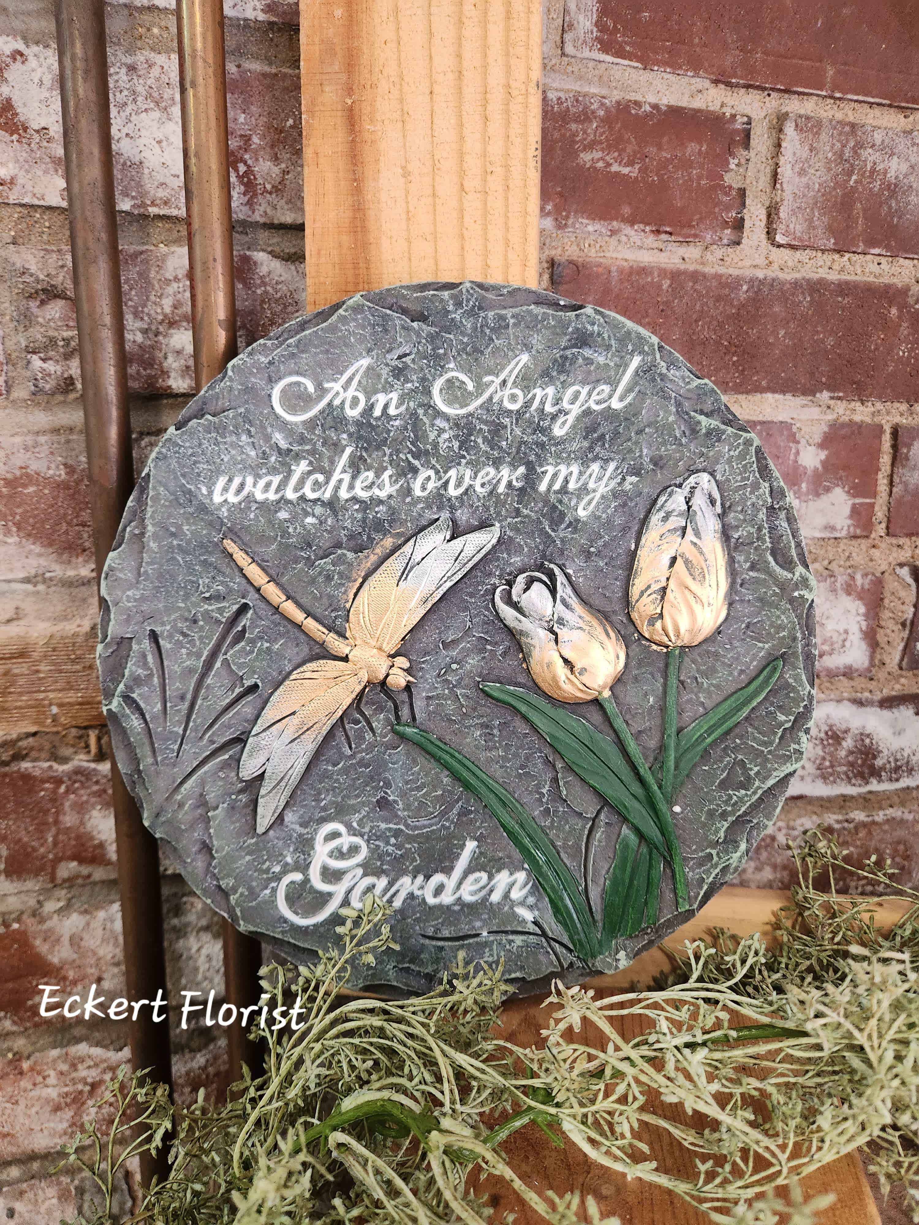 Round memorial plaque with a dragonfly and tulips, reading "An Angel watches over my Garden"