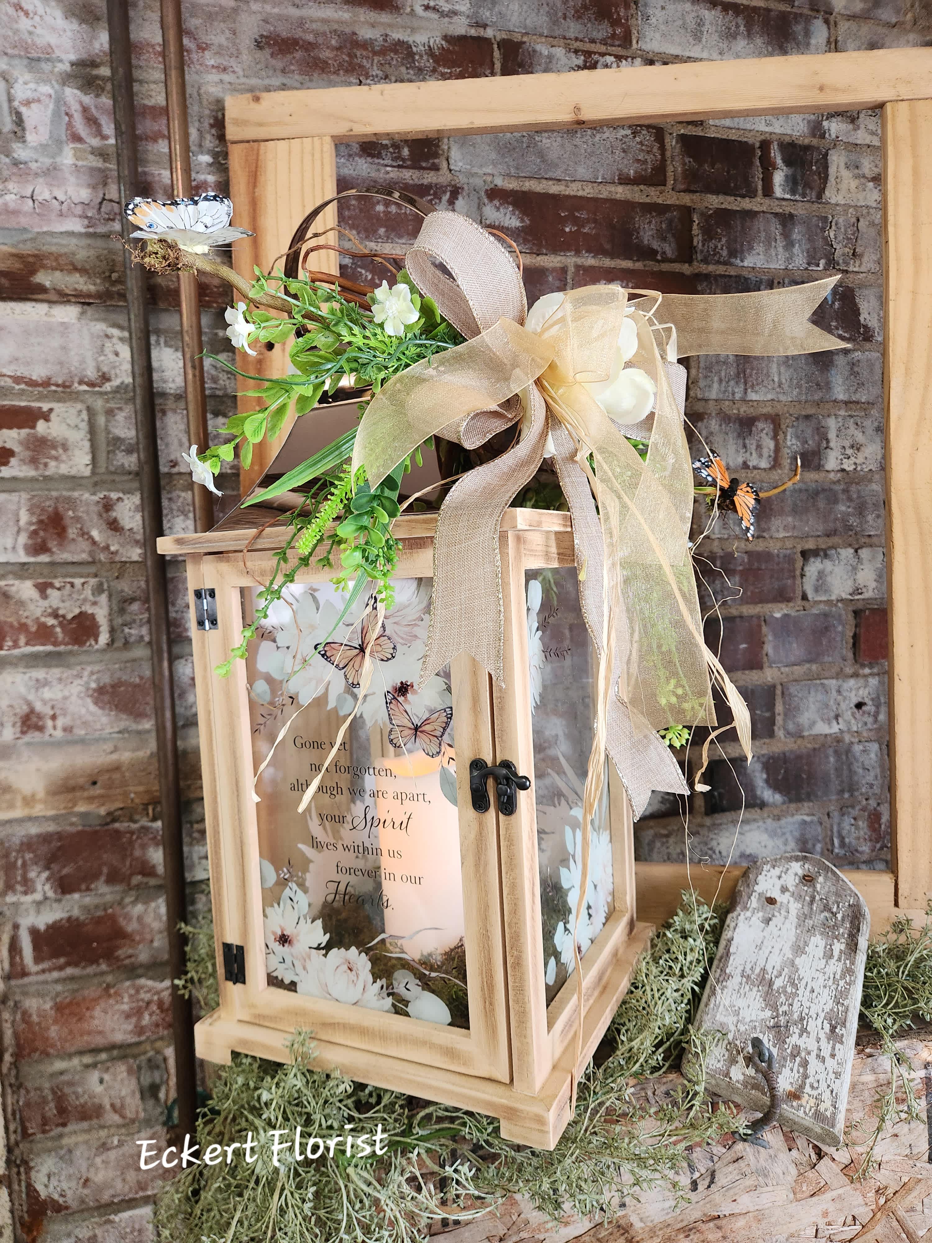 Eckert Florist's "Gone Yet Not Forgotten..." Large Copper Top Lantern *OUR LOCAL DELIVERY ONLY - Nice keepsake light wooden lantern with copper tin roof and sentiment on a floral and butterfly motif glass. Sentiment: "Gone yet not forgotten, although we are apart, your Spirit lives within us forever in our Hearts." Included is a battery operated candle. Measures approx. 8.75" Square x 20" High *OUR LOCAL DELIVERY ONLY