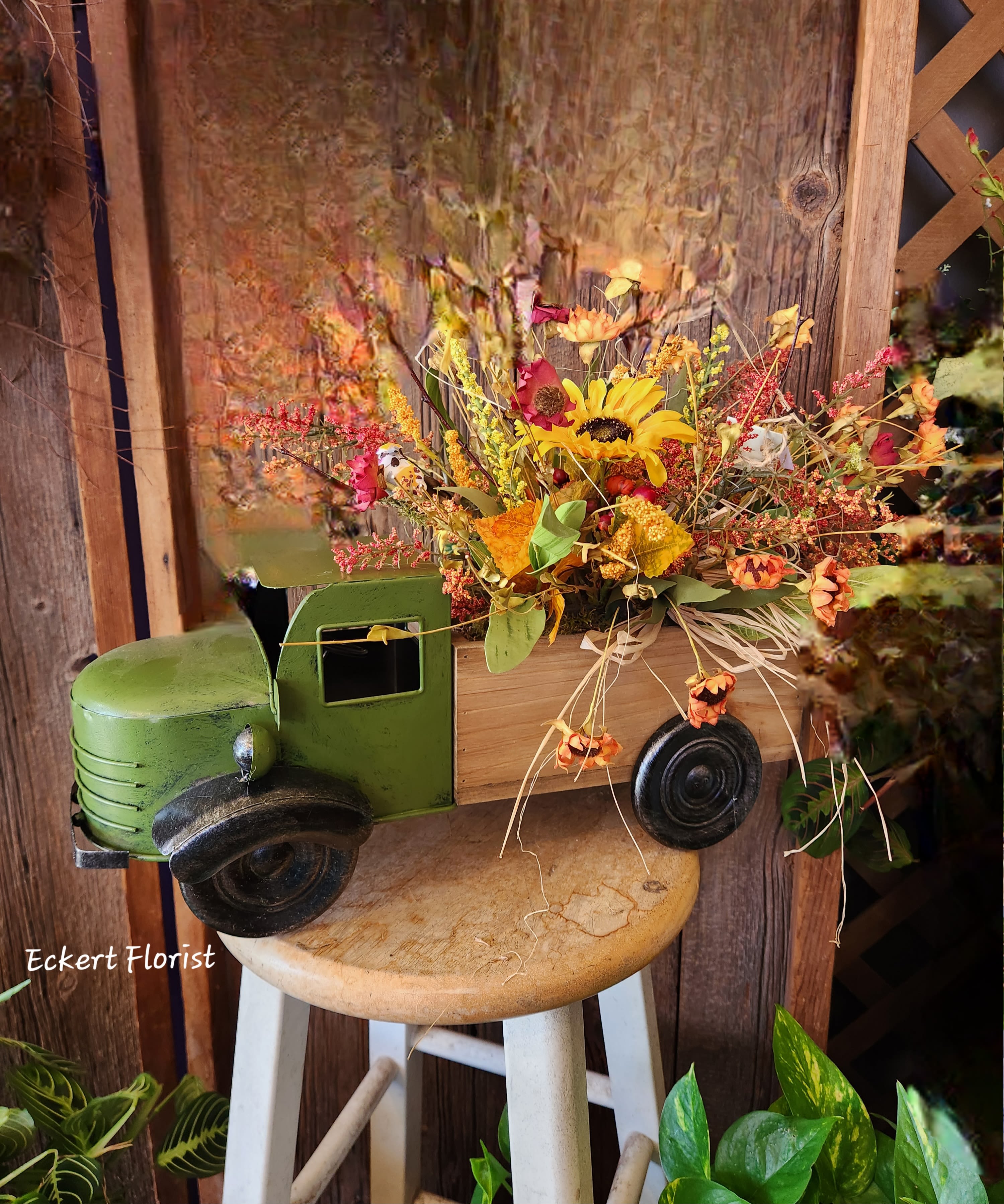 Fall floral arrangement in a decorative truck container