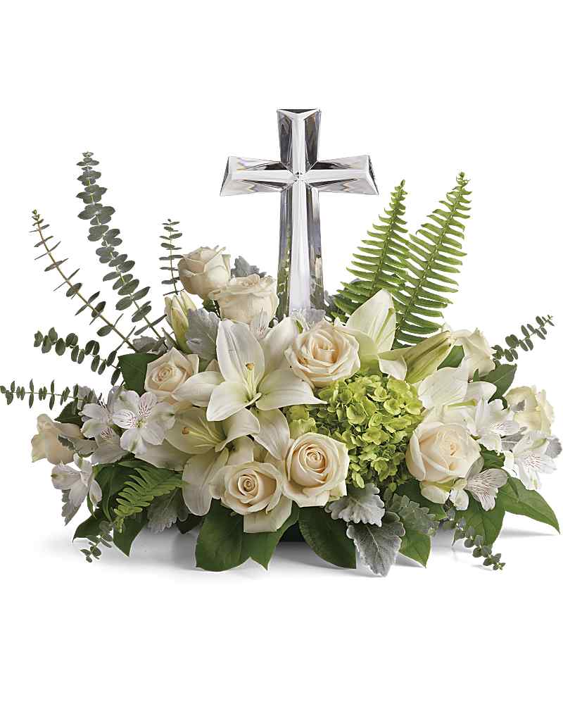 White floral arrangement with a clear cross centerpiece