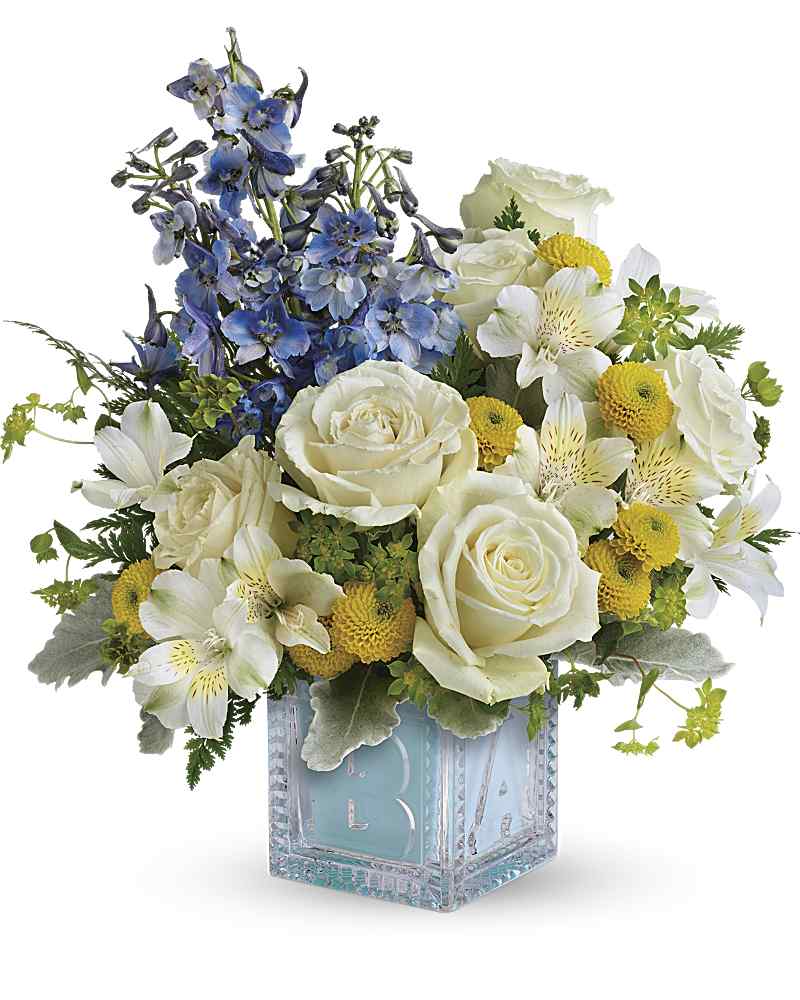 Blue and white floral arrangement in a clear square vase