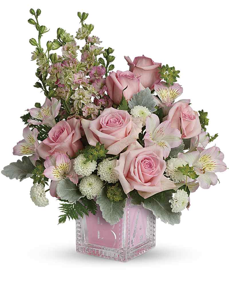 Pink roses and alstroemeria in a clear square vase
