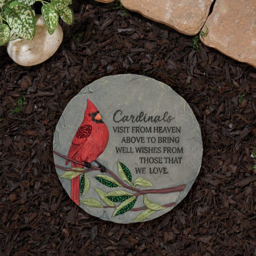 Round memorial stone with a red cardinal and engraved text
