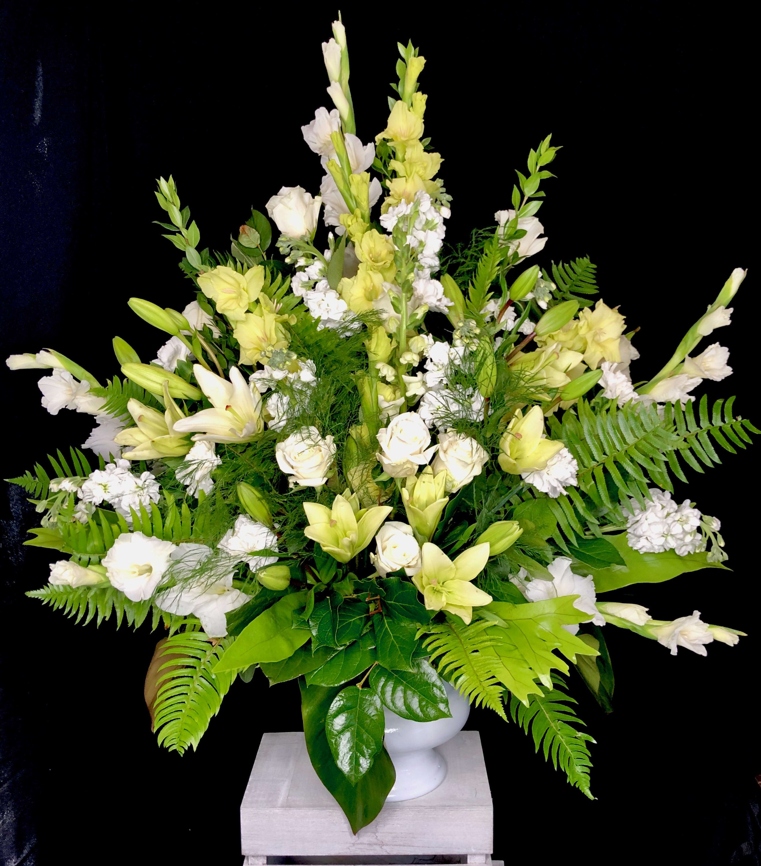 Eternal Bliss - A beautiful display of all white, green, and yellow flowers – including blossoms like gladioli, carnations and stock – will show your thoughtfulness and sentimentality.