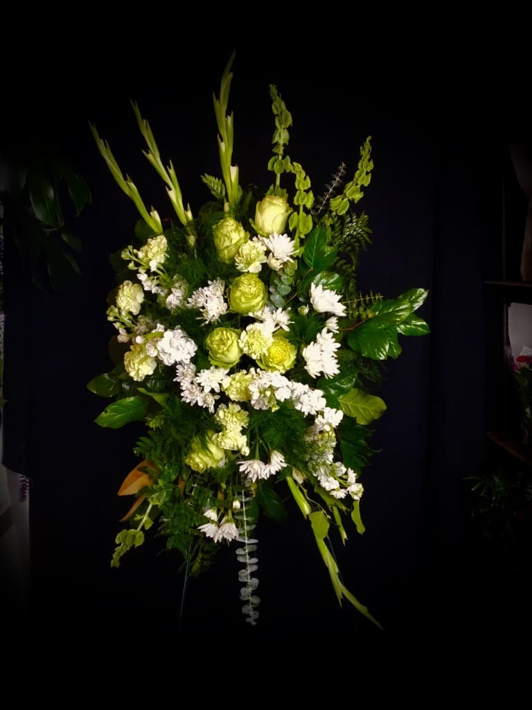 Tall green and white floral spray with mixed blooms