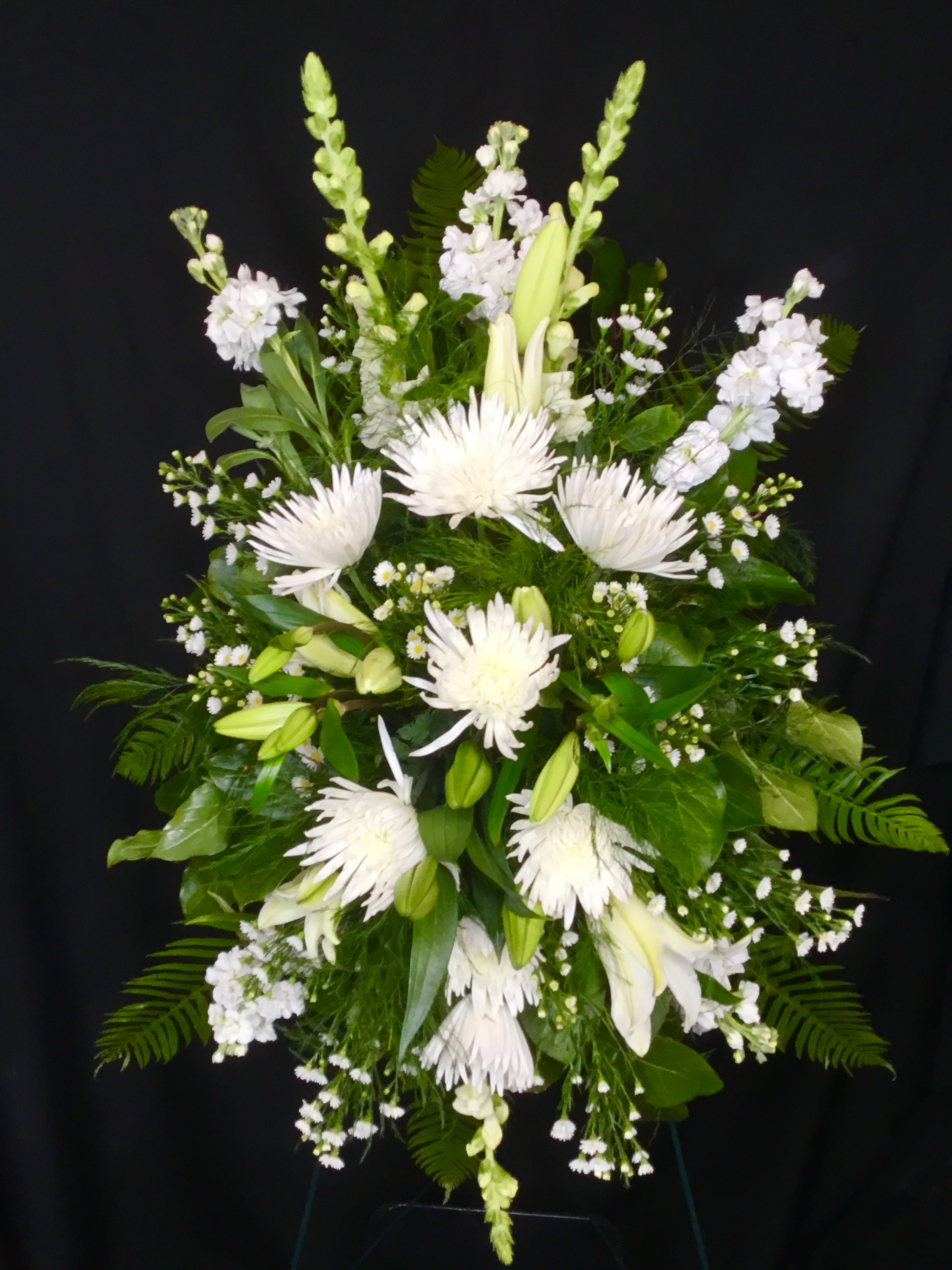 White floral standing spray with lilies and spider mums