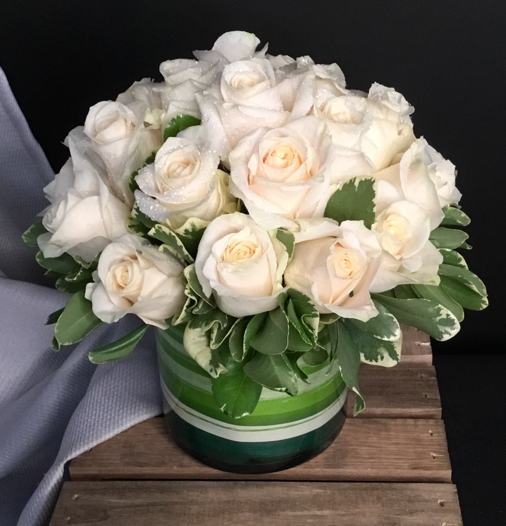 Pinot Grigio - Classic, elegant, and timeless, this splendid display of 24 white roses is a great way to mark a special occasion or send your sympathies. Arranged tightly with very little filler or greens, this arrangement doesn't shy away from being the center of attention!