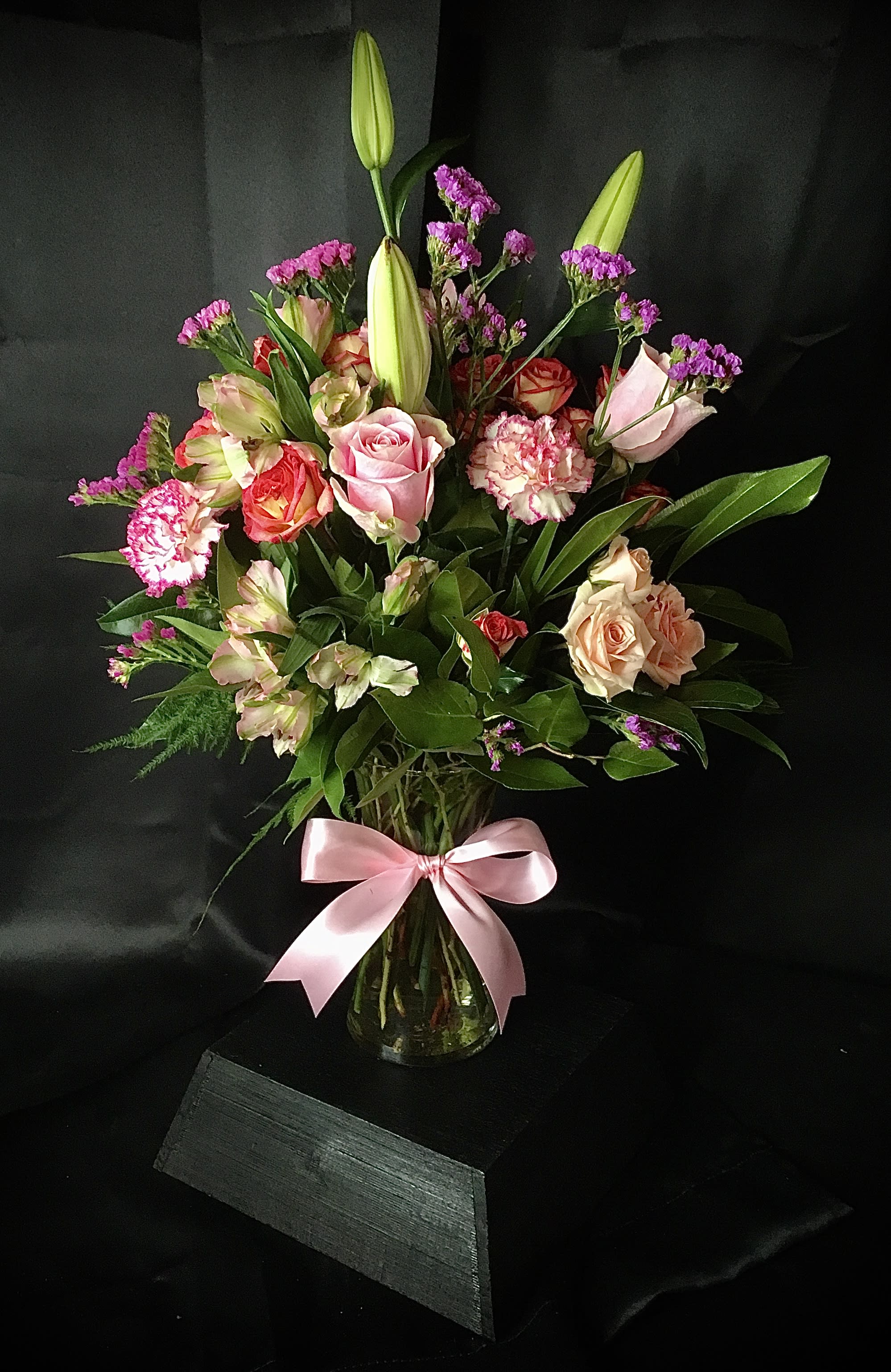 The Pink Pussycat - A fun, festive mix of pretty pink blossoms – including roses, lilies and stock, in complementary blush tones – creates a magnificent display that’s a lovely gesture for a birthday, anniversary or other special day.
