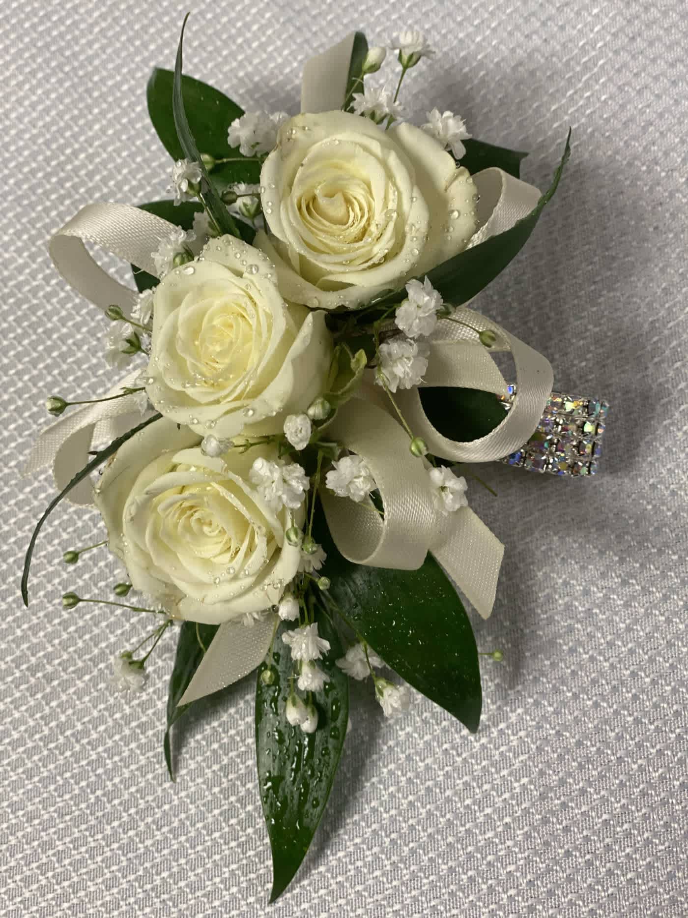 White Rose Corsage  - A classic white corsage hand-tied in white ribbon that compliments any outfit. A beautiful addition to any prom, formal, or wedding event.  Please let us know in the special instructions if you would like  an accent color added.