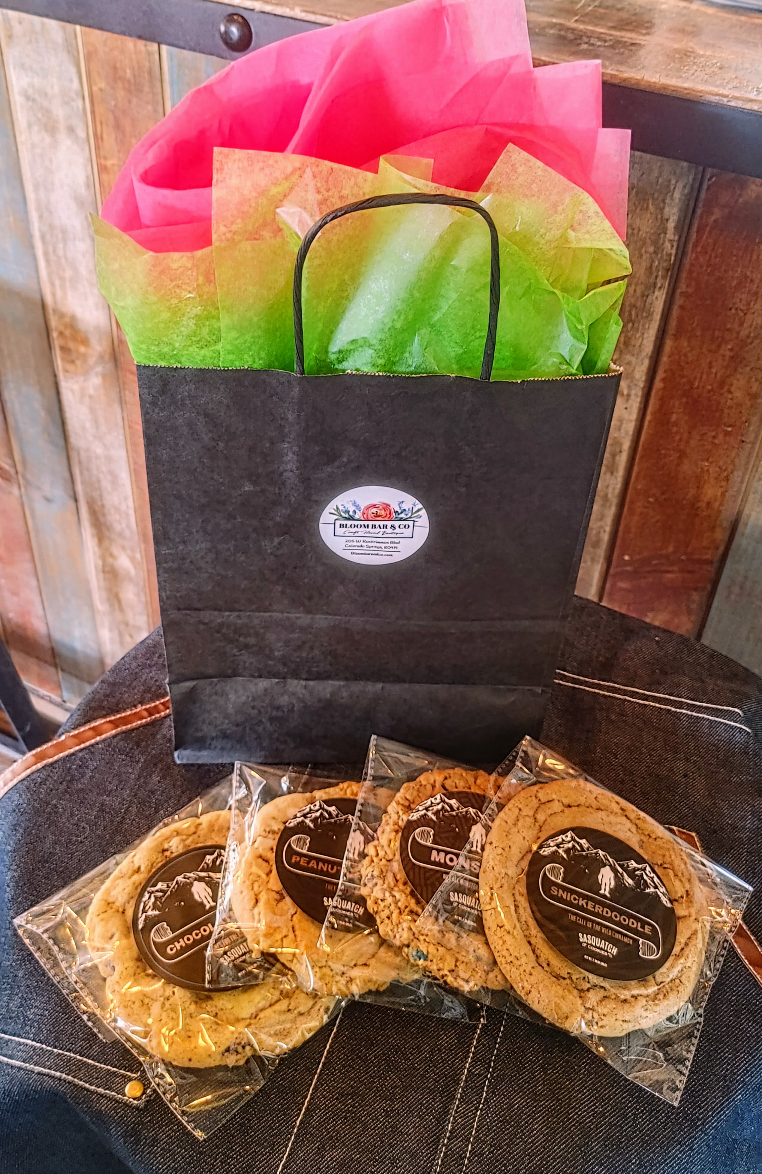Gift bag with wrapped cookies on a chair