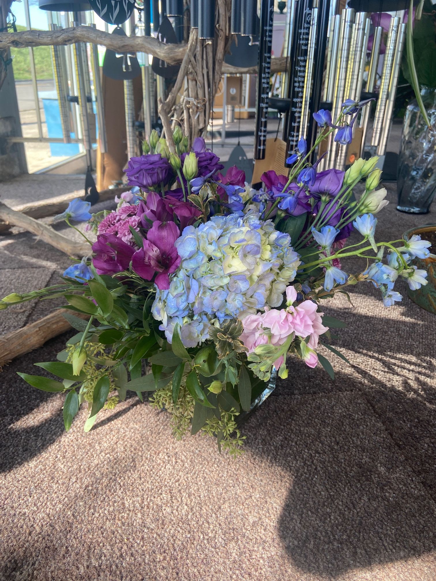 Lavender Blue Cube - Square cube leaf lined and filled with blue hydrangea, lavender stock, blue delphinium and a mix of seasonal accent flowers.