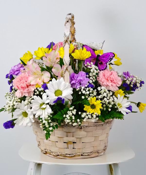 Beautiful Garden Basket  - Shallow woven basket overflowing with white, pink, yellow &amp; purple blooms, central candle and butterfly accent