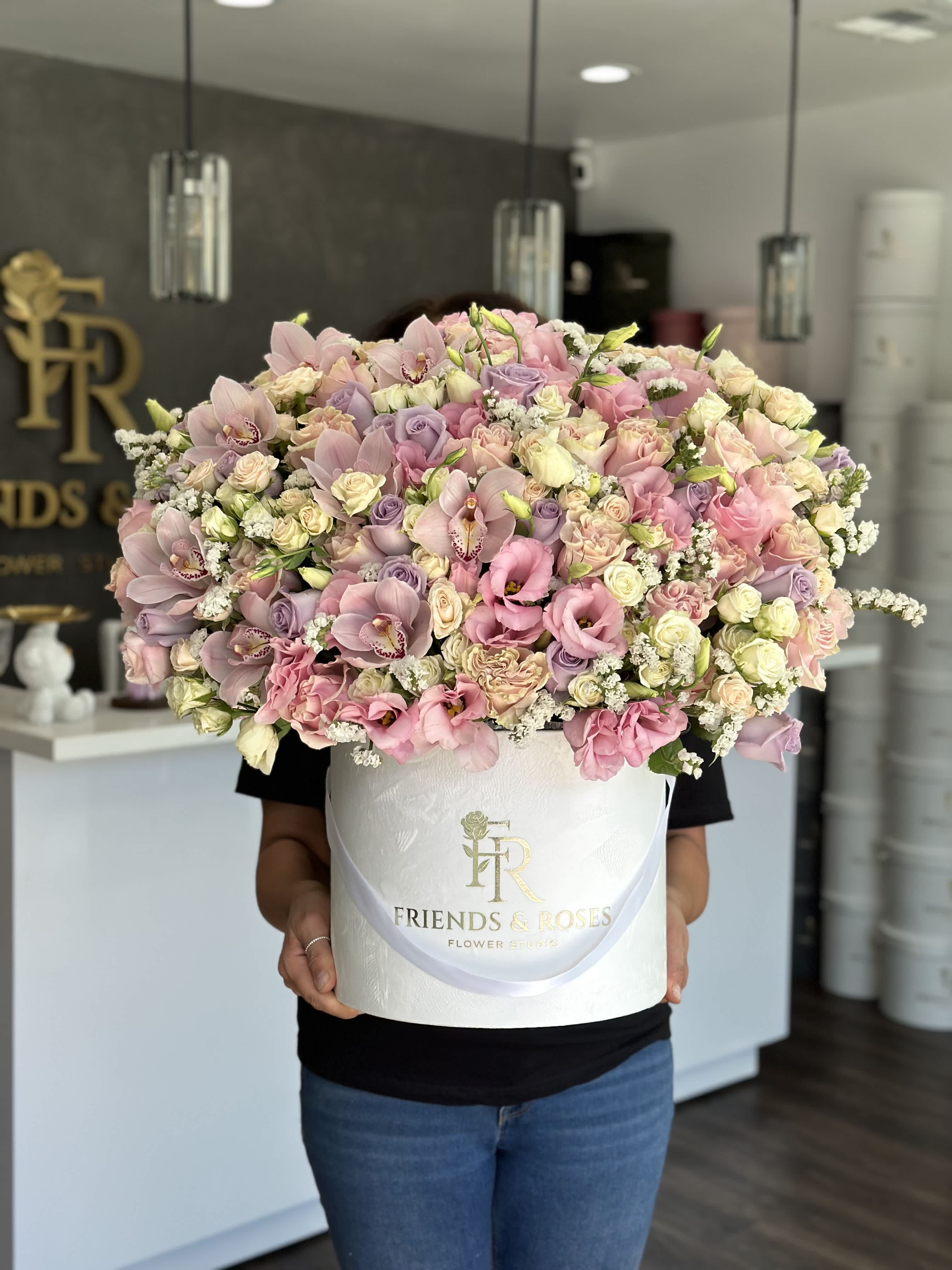 Large pastel bouquet in a white hatbox with pink and lavender flowers