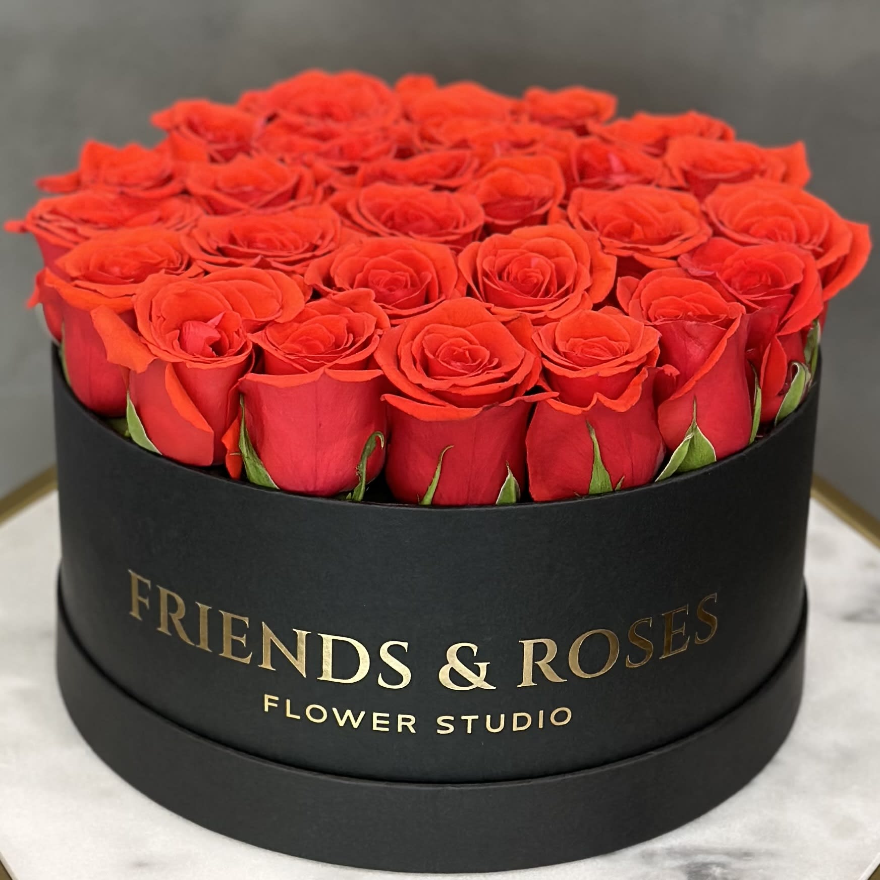 Round box filled with red roses