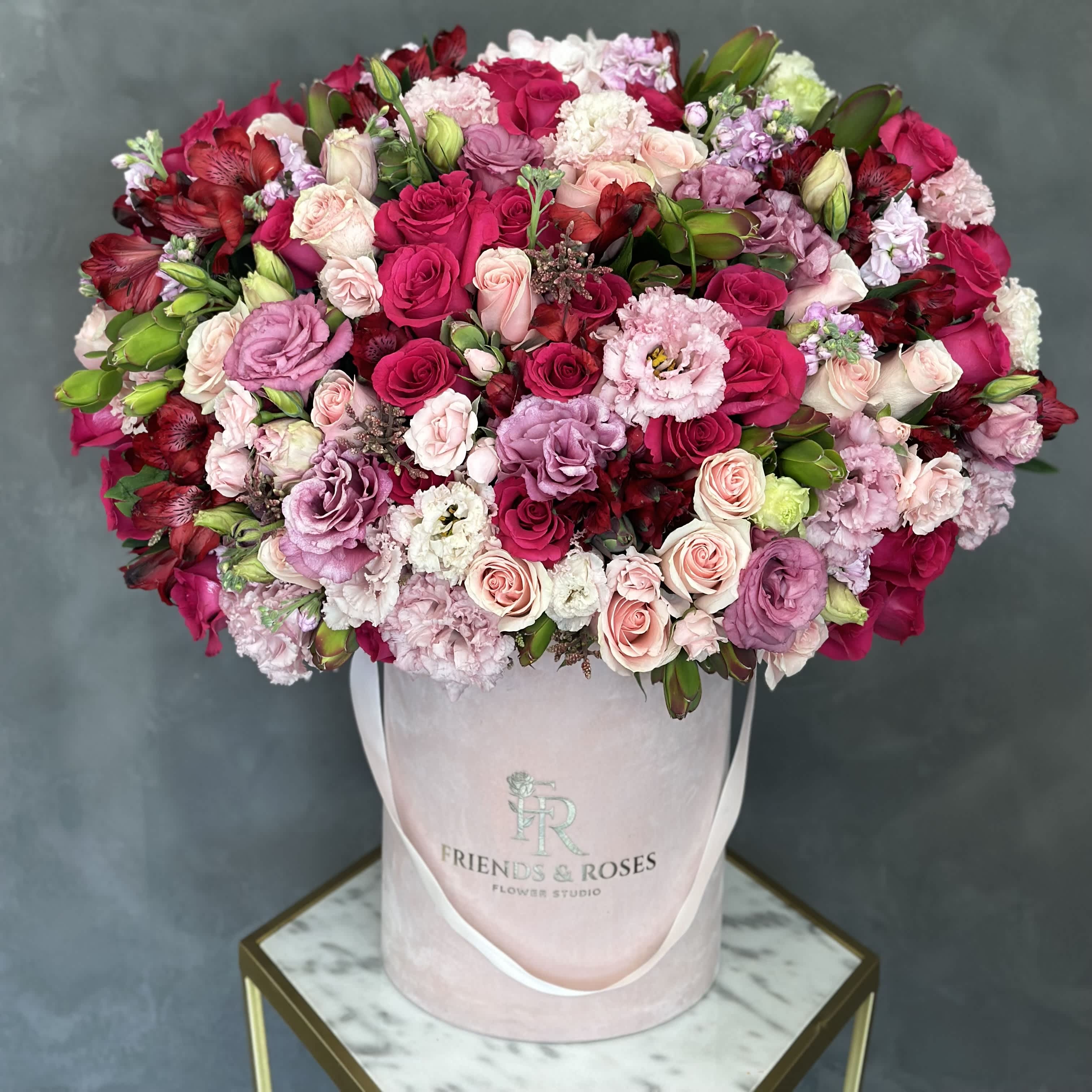 Large pink and red rose bouquet in a pale pink hatbox