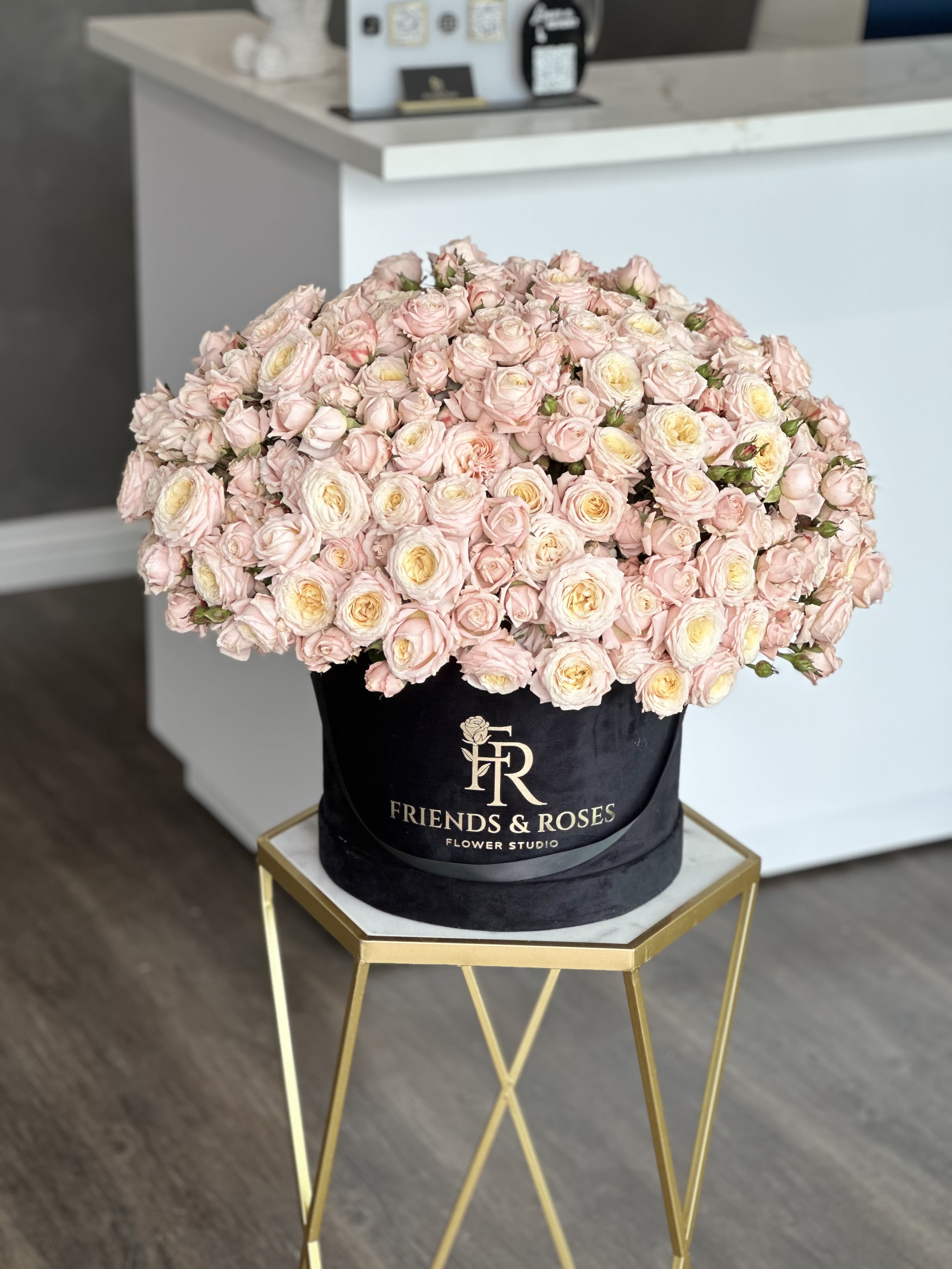 Large box of pale pink roses with cream centers