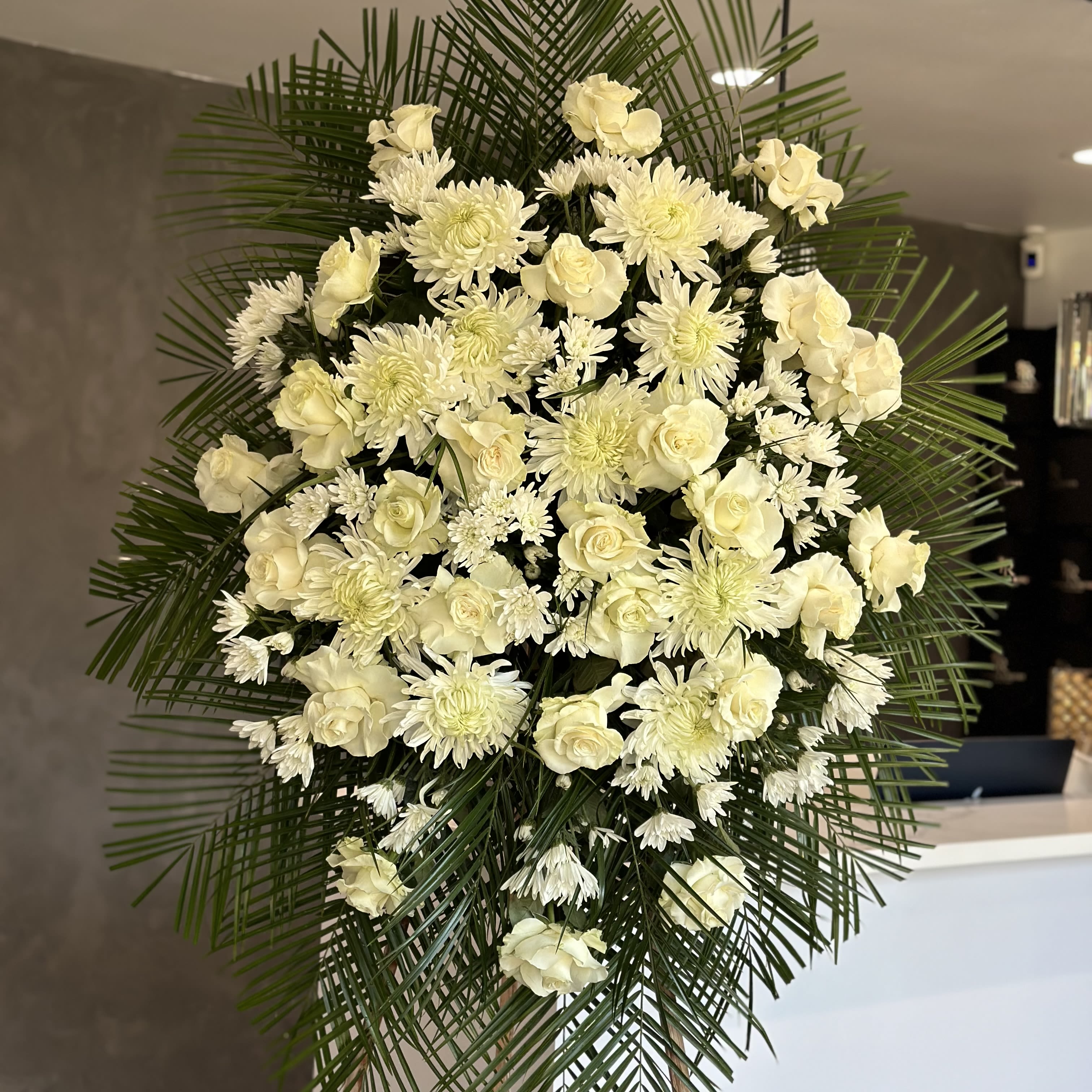 White floral standing spray with roses and chrysanthemums