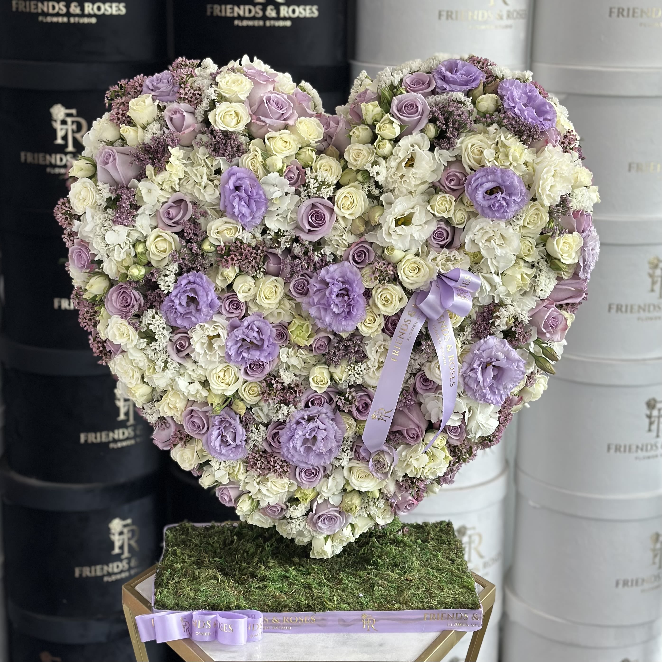 Heart-shaped floral arrangement in lavender, white, and cream tones